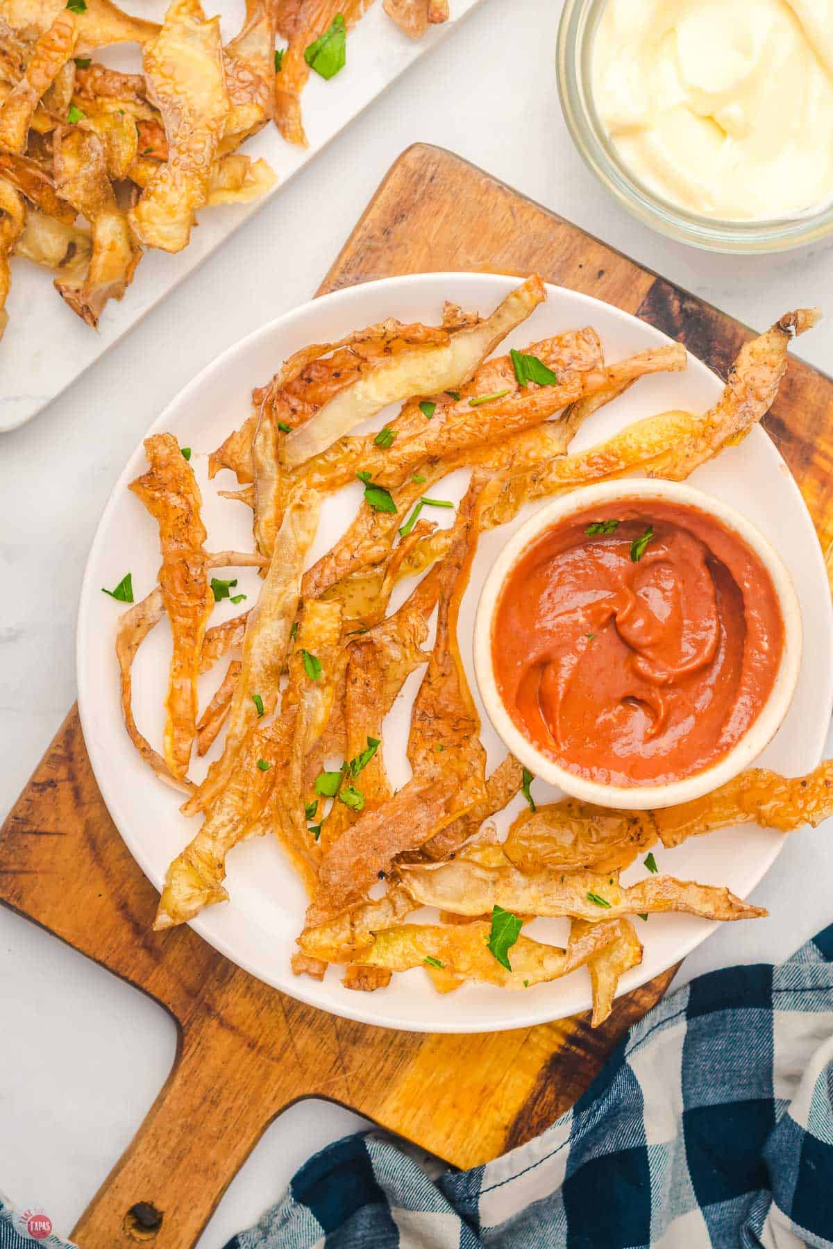 overhead picture of potato skin chips with a bowl of dip
