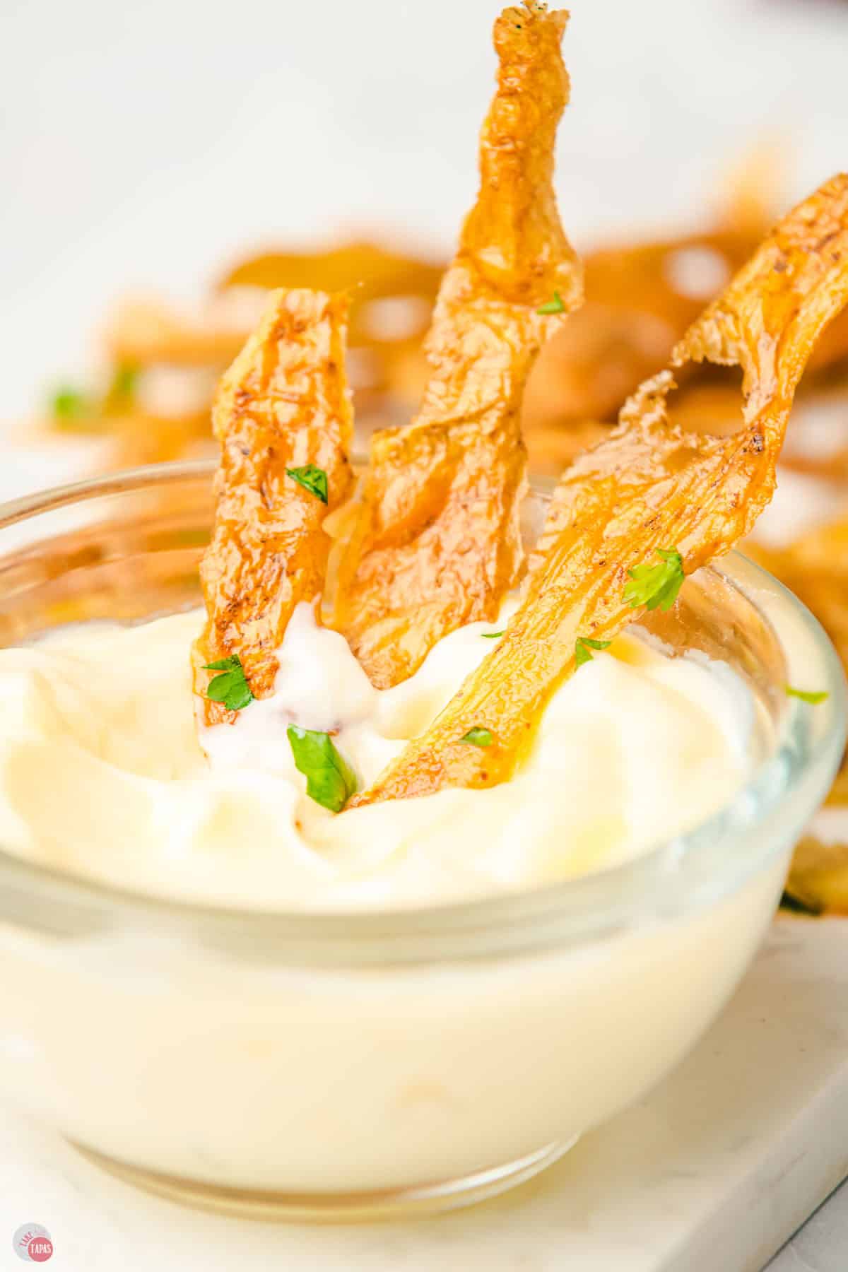 bowl of dip with potato skin chips in it