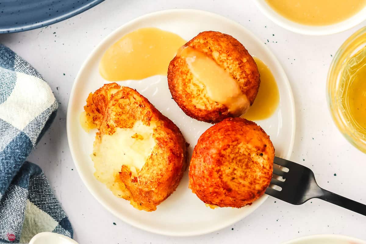 poutine poppers on a plate with gravy and a fork