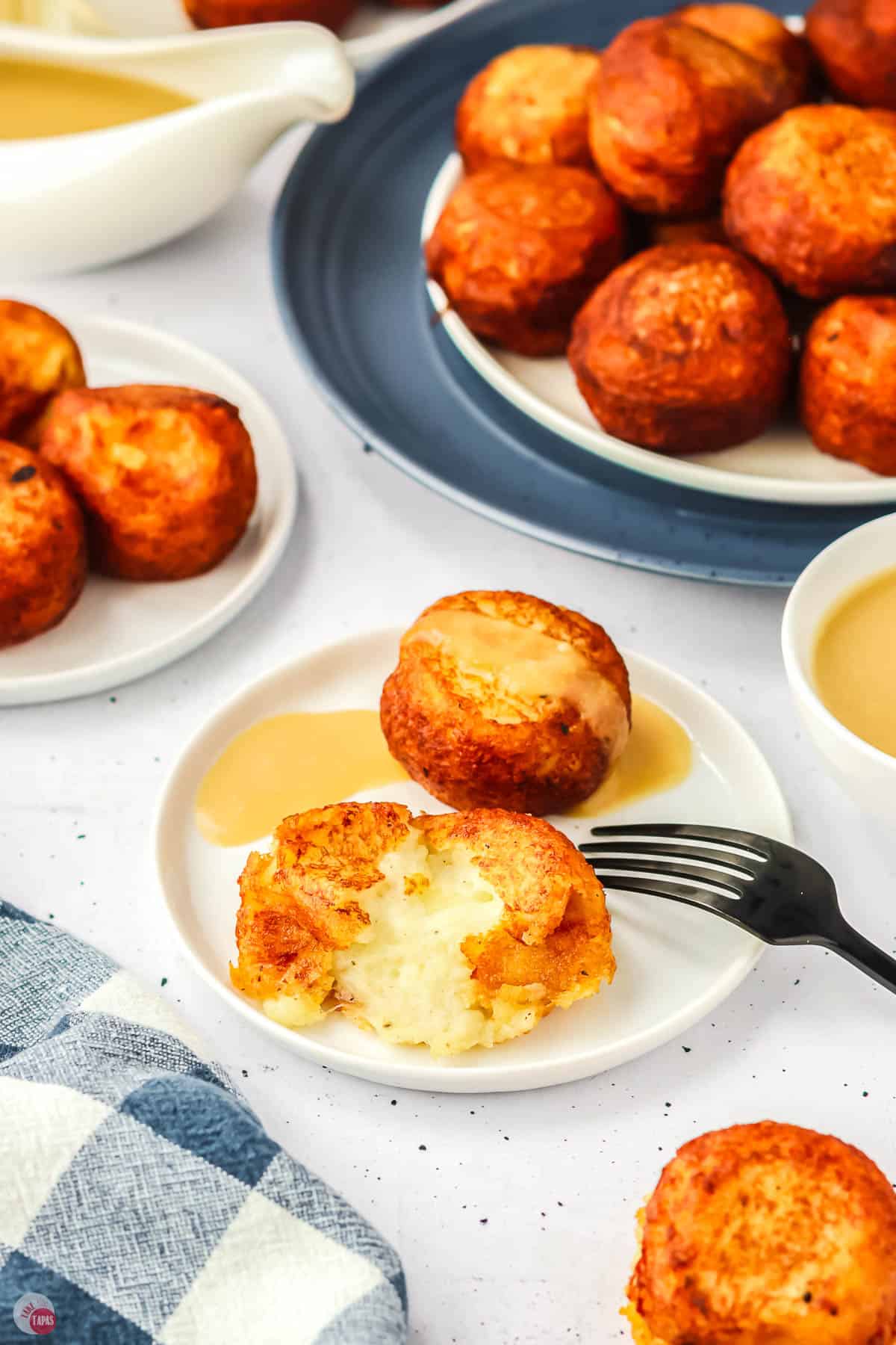 poutine poppers on a plate with a fork