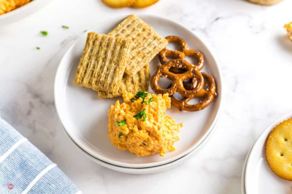 plate of pub cheese with crackers and pretzels