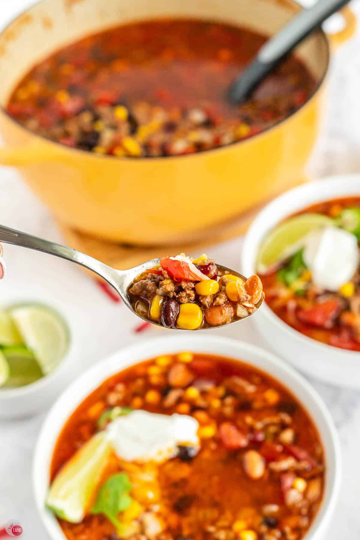 spoon of santa fe soup above a white bowl