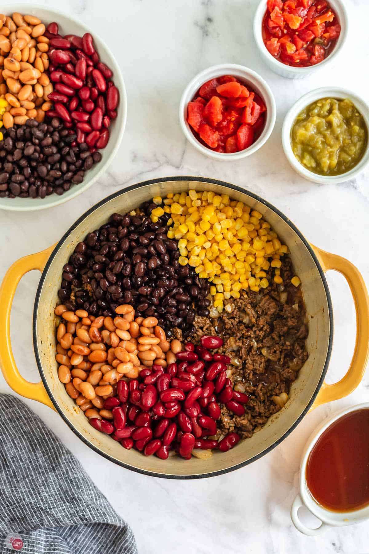 beans and corn in a yellow pot