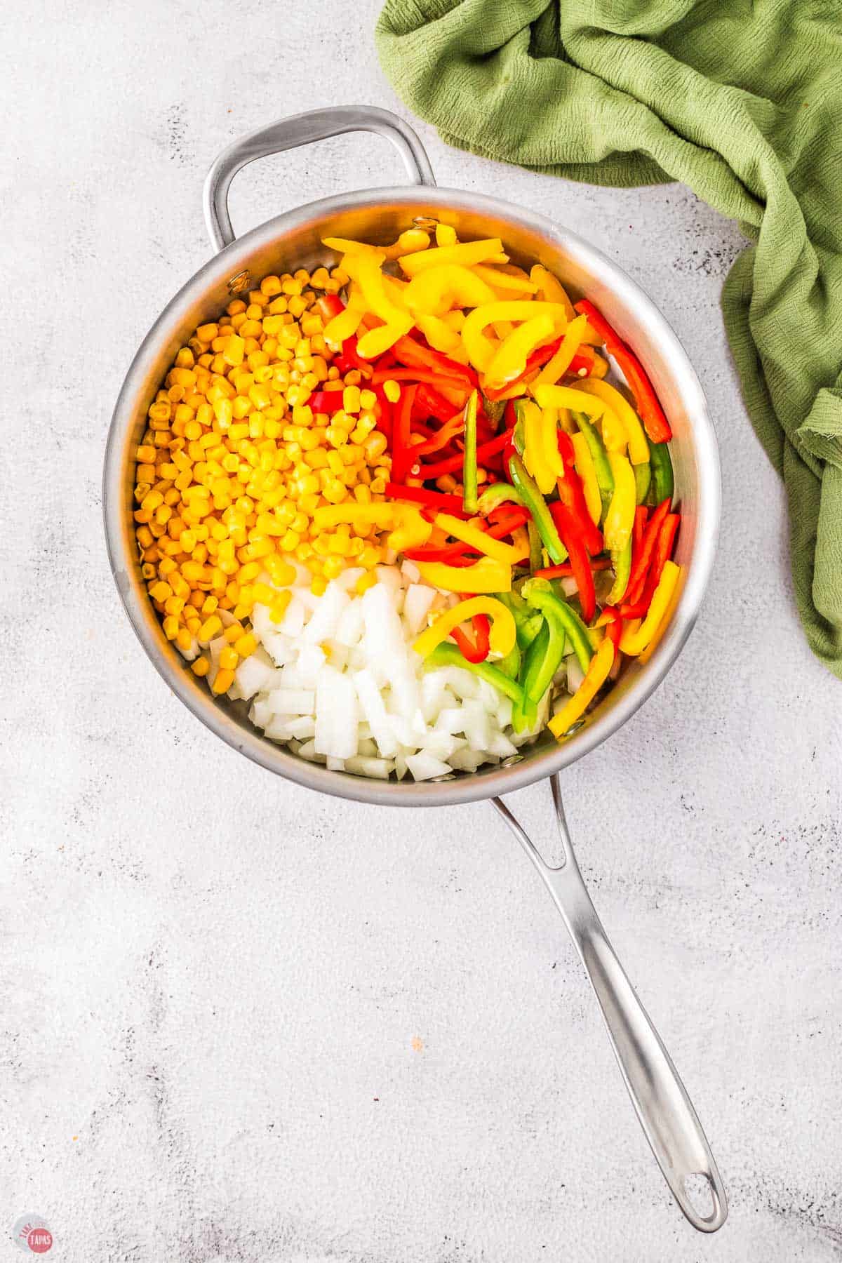 bell peppers, corn, and onion in a skillet