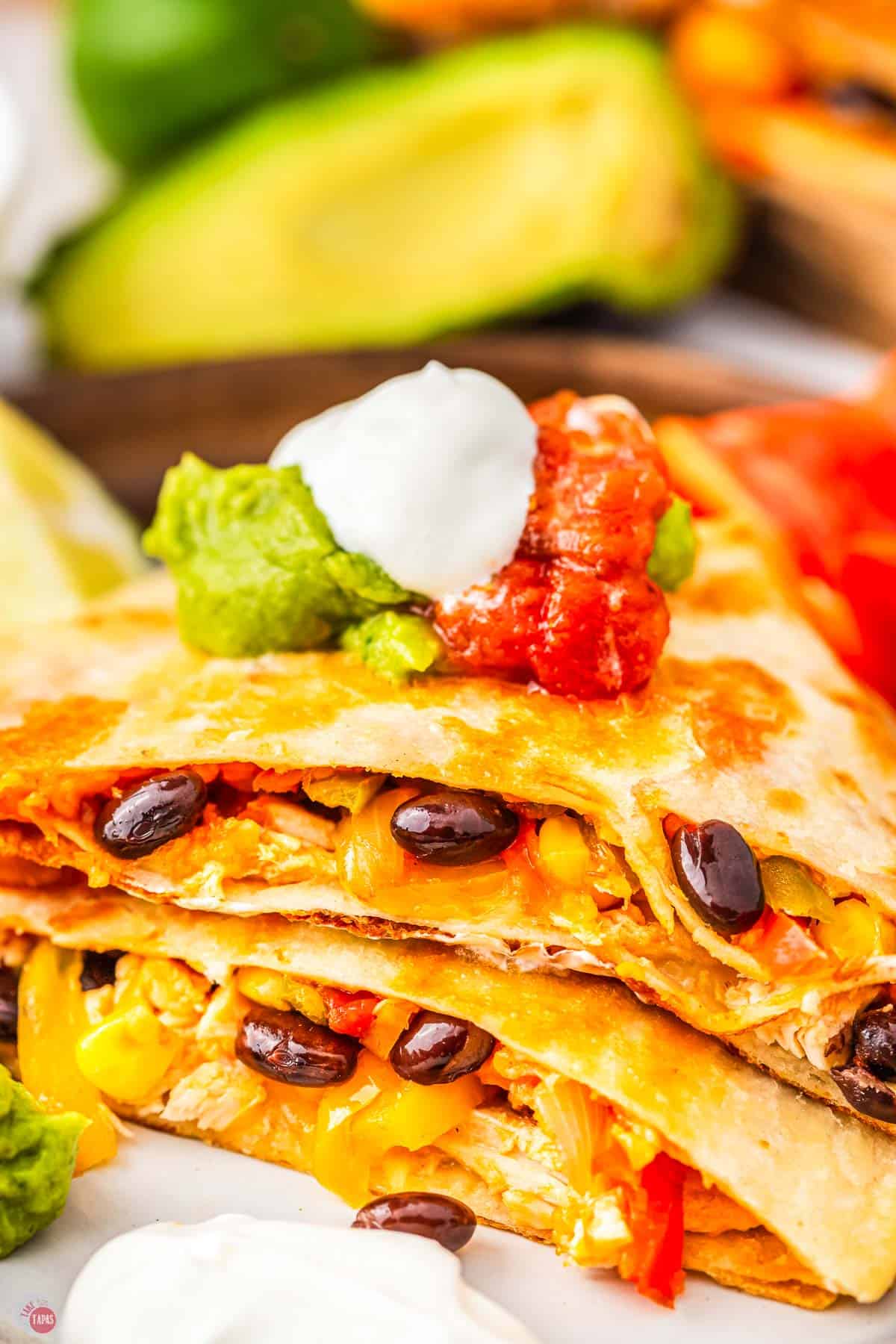close up of side of cut quesadilla with black beans
