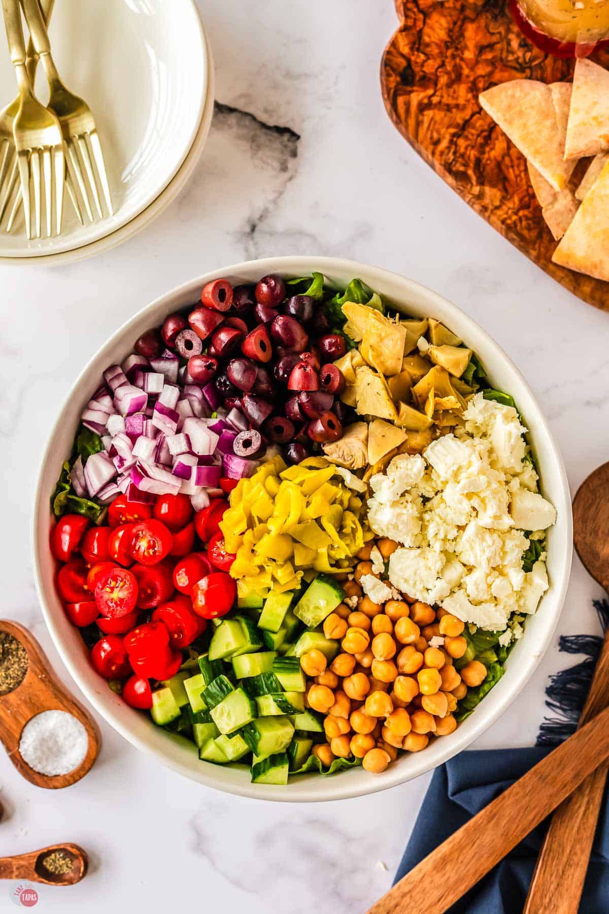 unmixed chopped salad ingredients in a white bowl