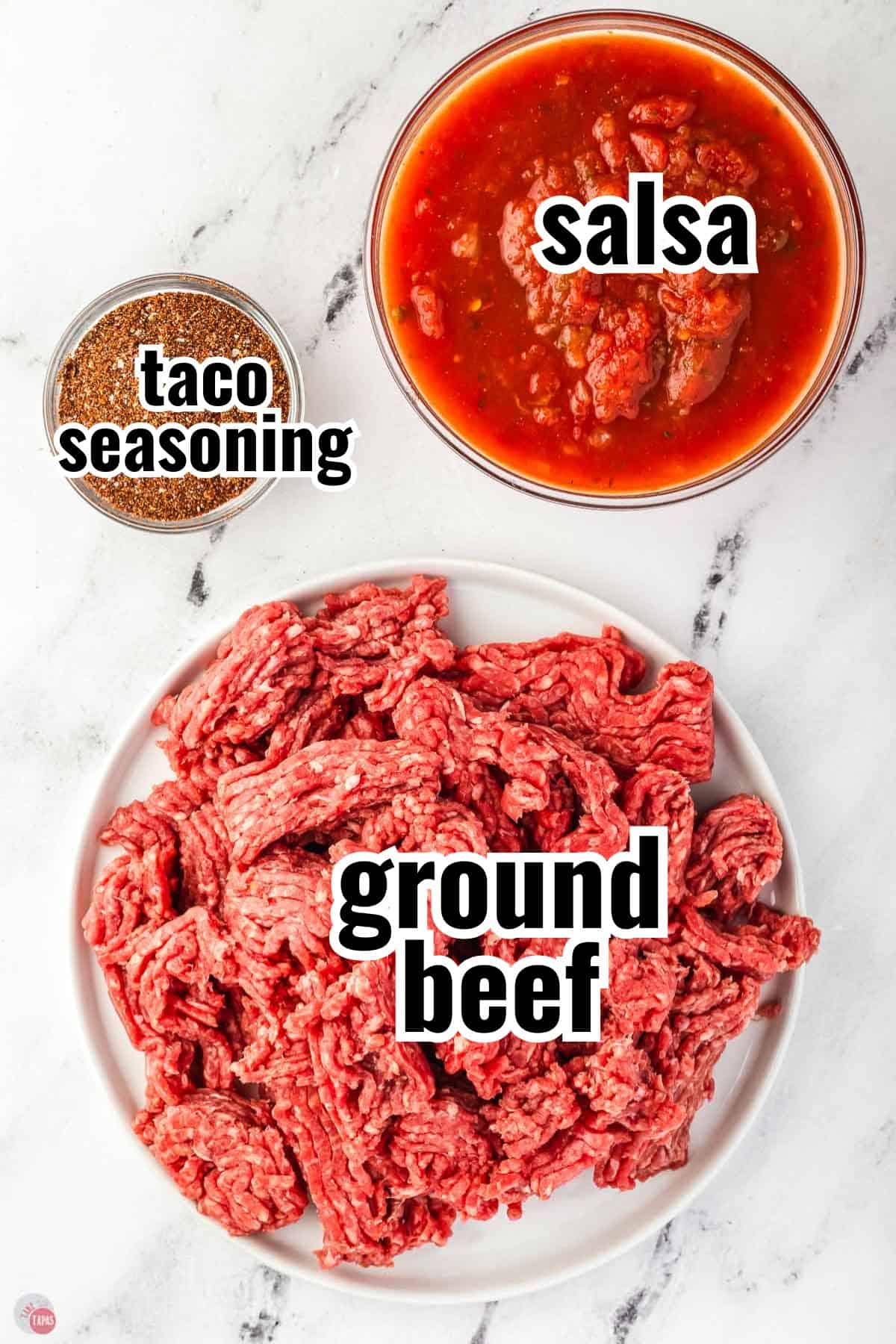 ingredients for a taco meat recipe on a marble counter