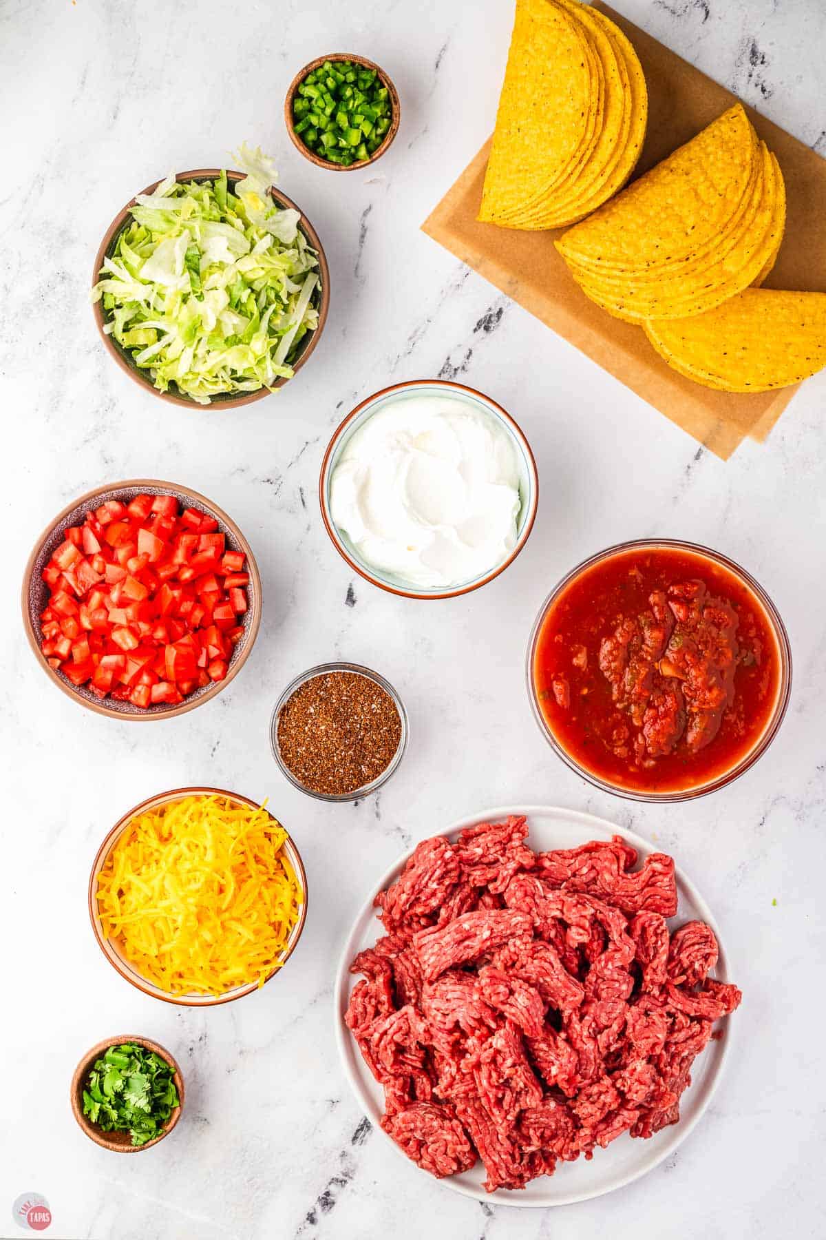 ingredients for a taco bar on a marble counter
