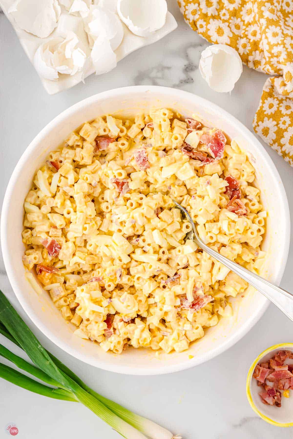 pasta salad in a white bowl with a fork