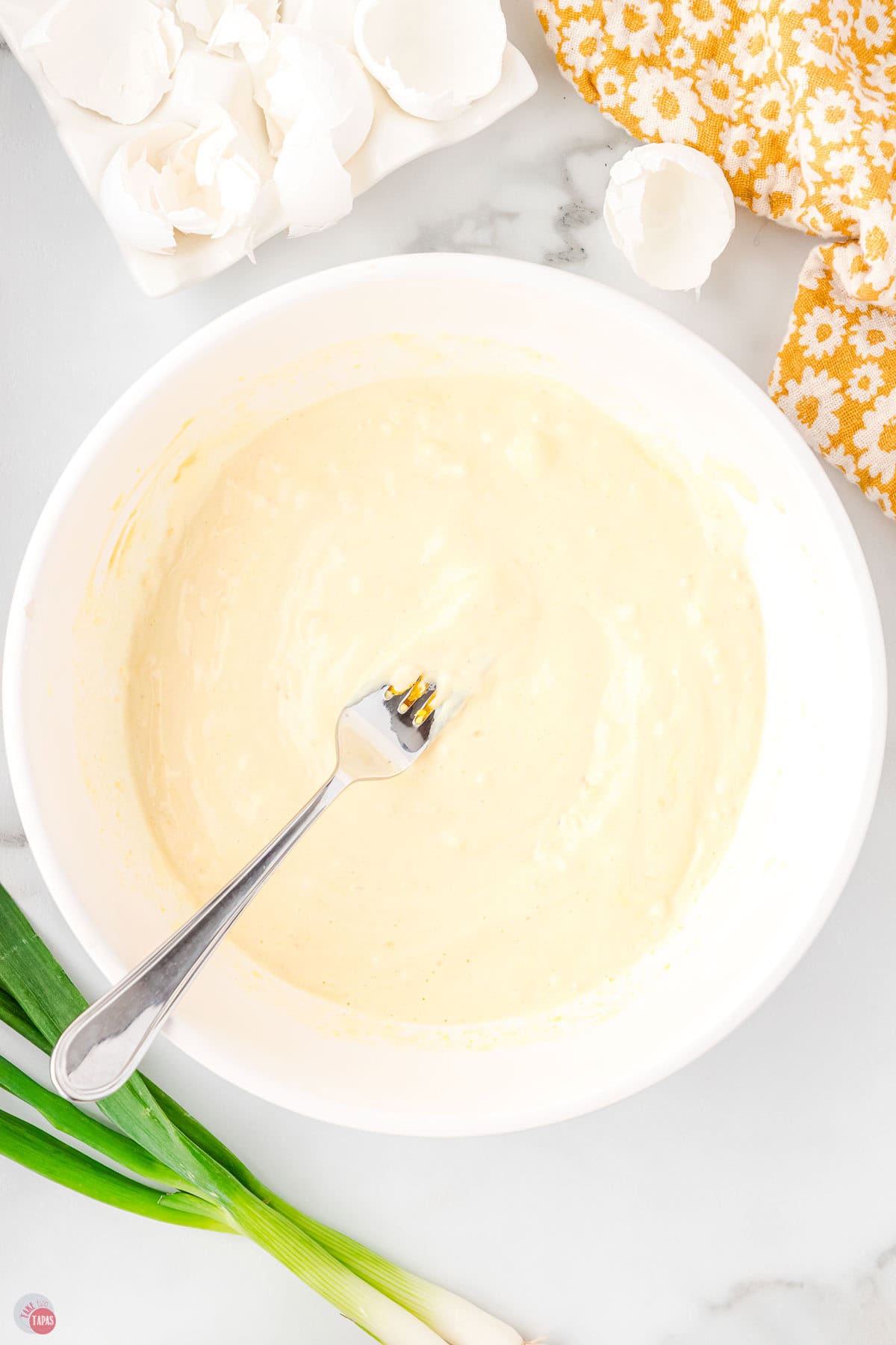 deviled egg dressing in a white bowl with a fork