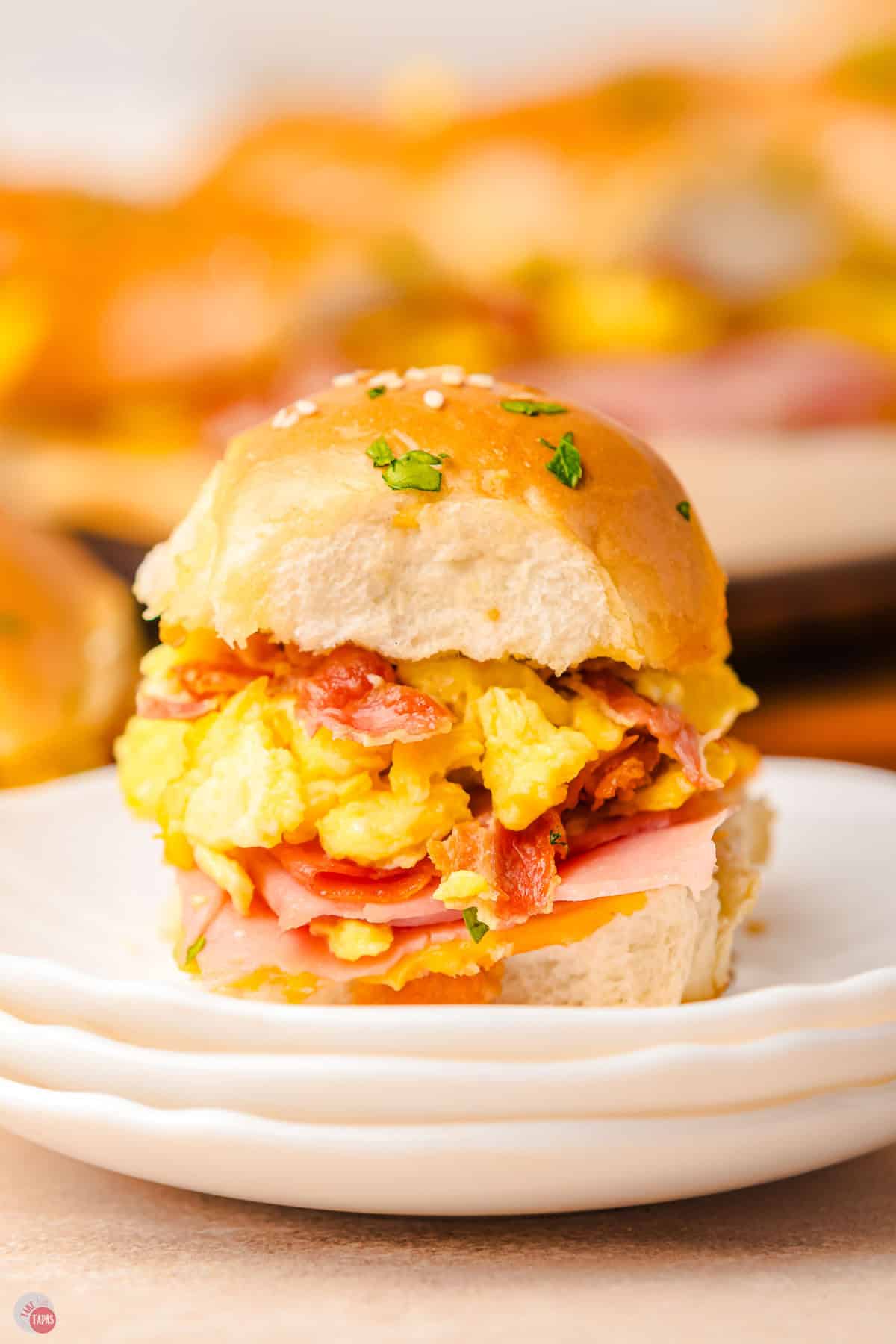 close up of breakfast slider on a stack of plates