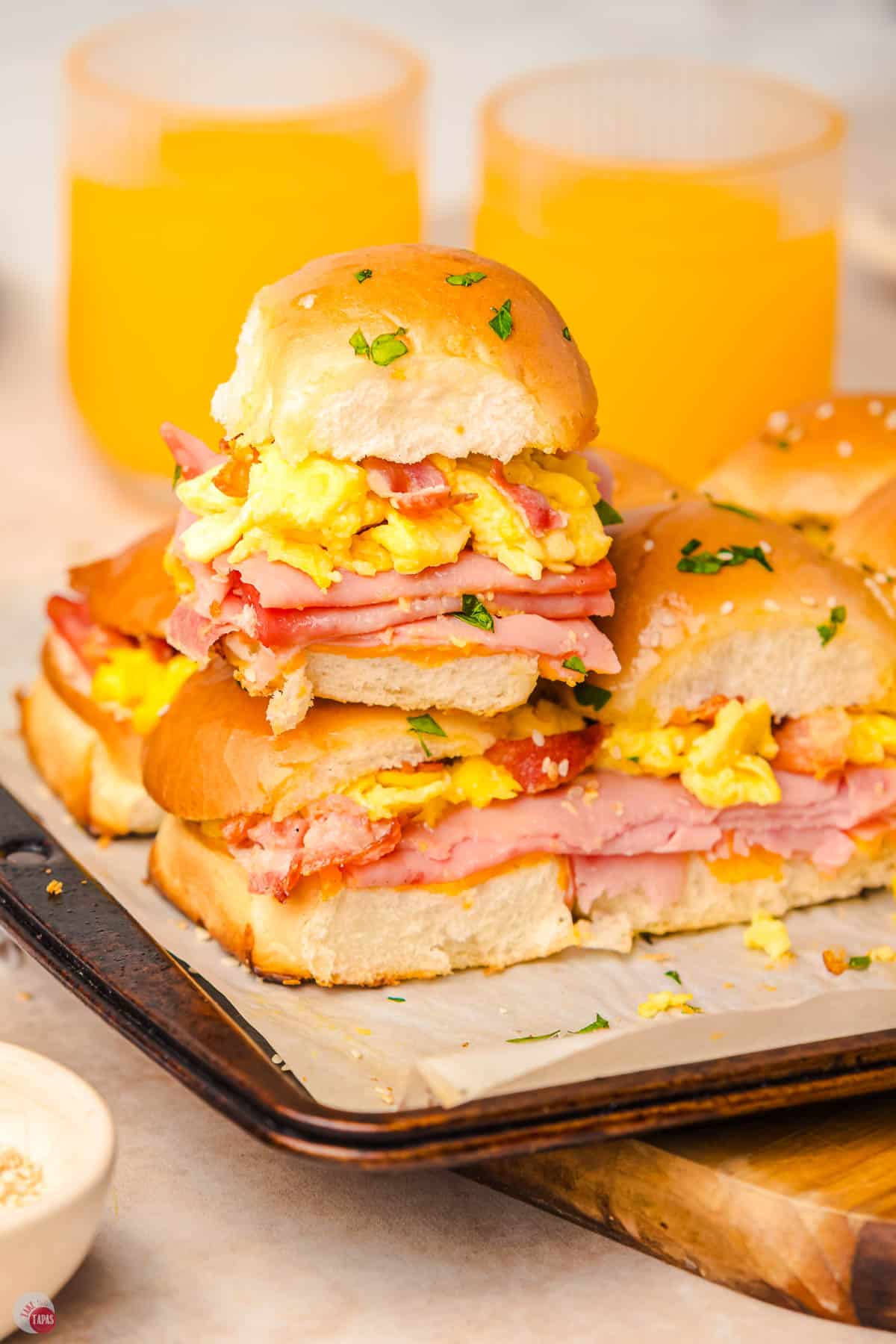 baking sheet of breakfast sliders with one on top of the others