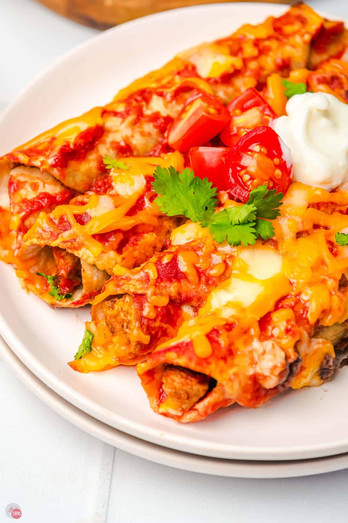 enchiladas on a stack of white plates