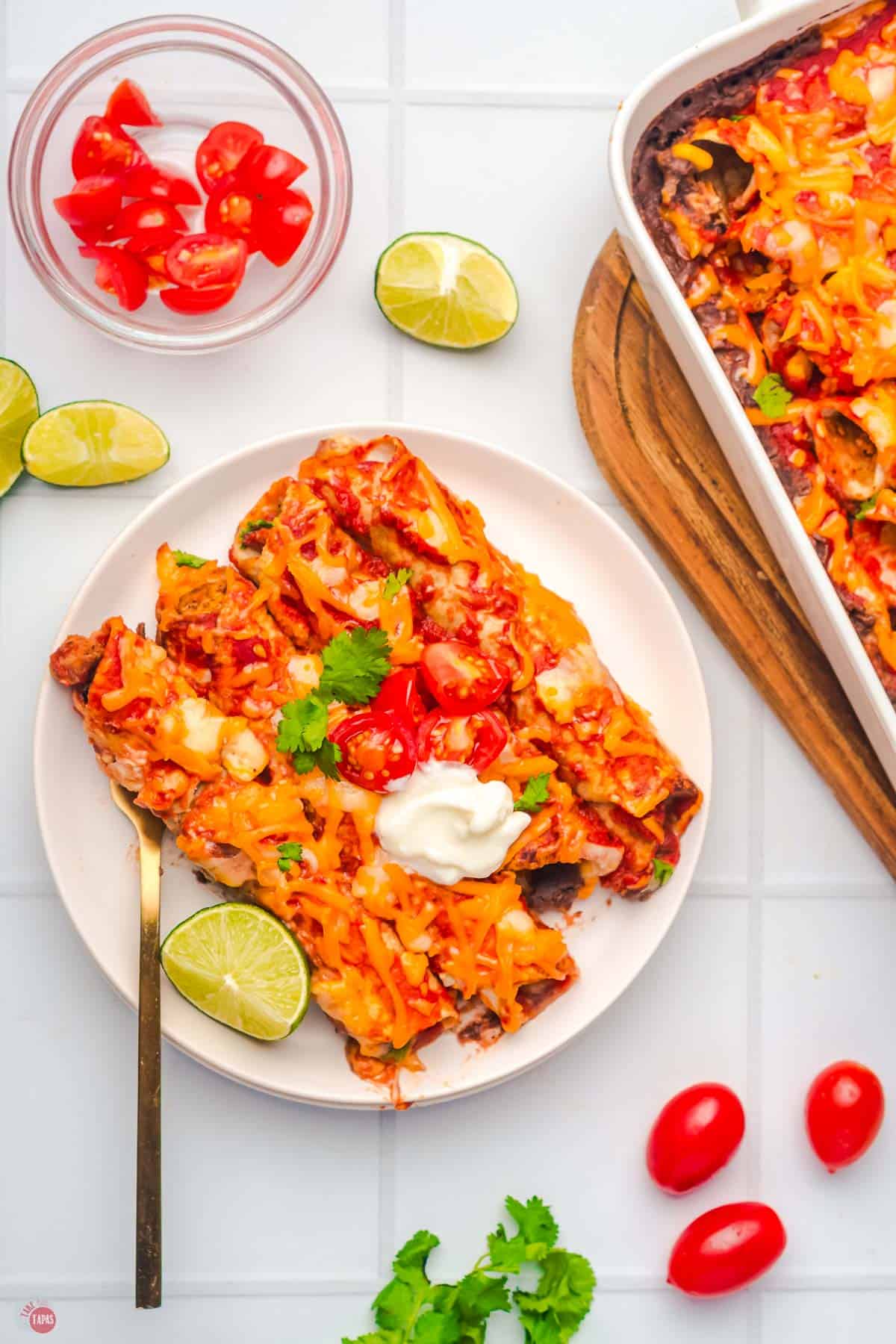 overhead picture of plate of enchiladas next to a baking dish
