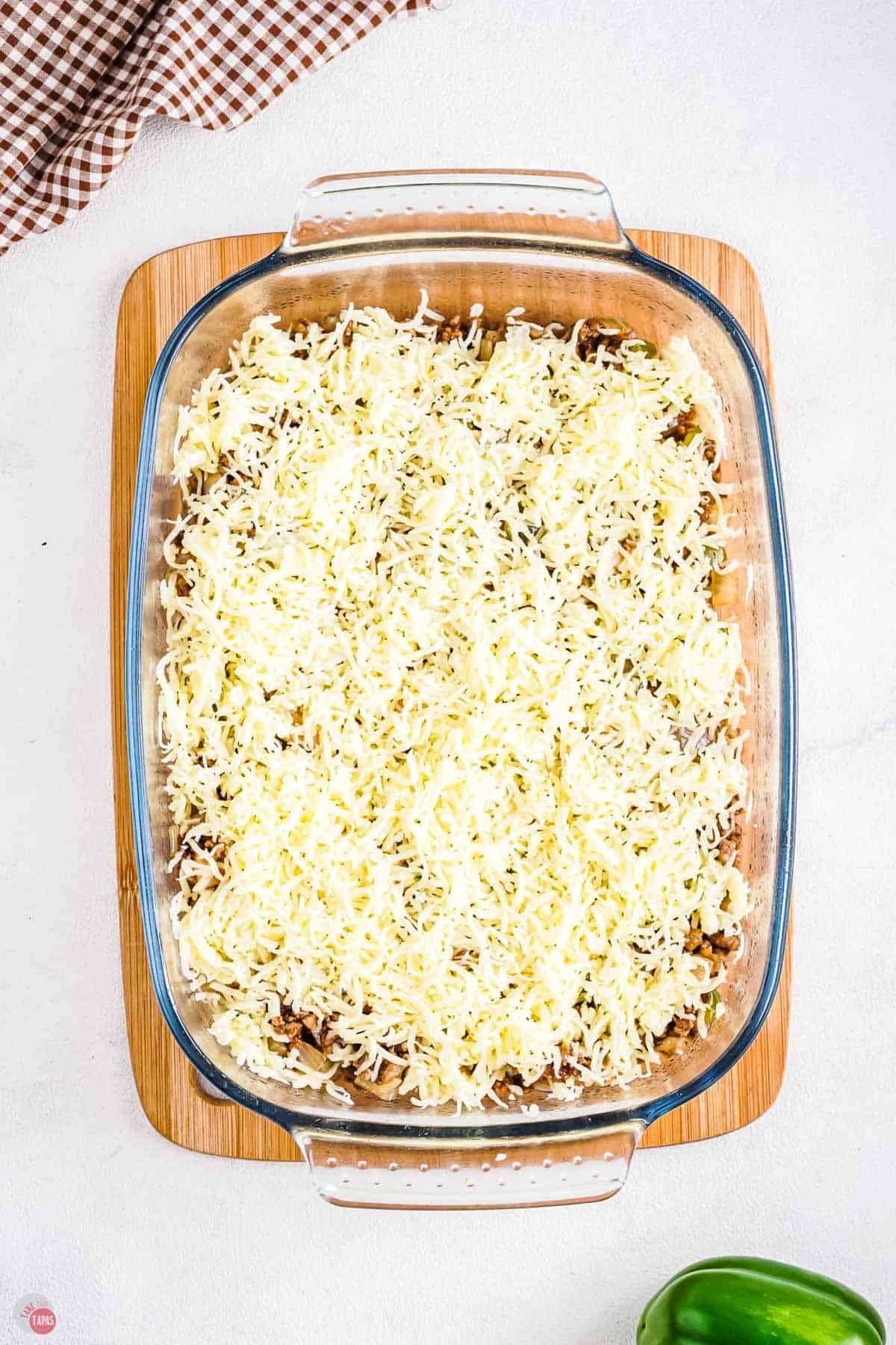 casserole dish with shredded cheese