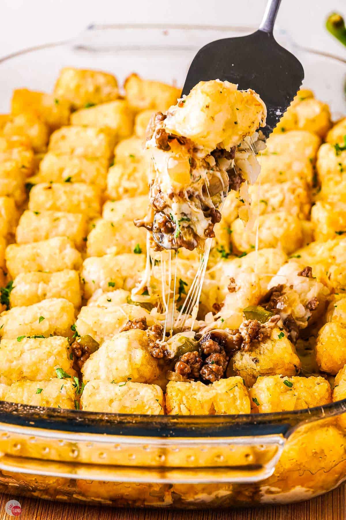 closeup of philly cheesesteak tater tot casserole with melted cheese