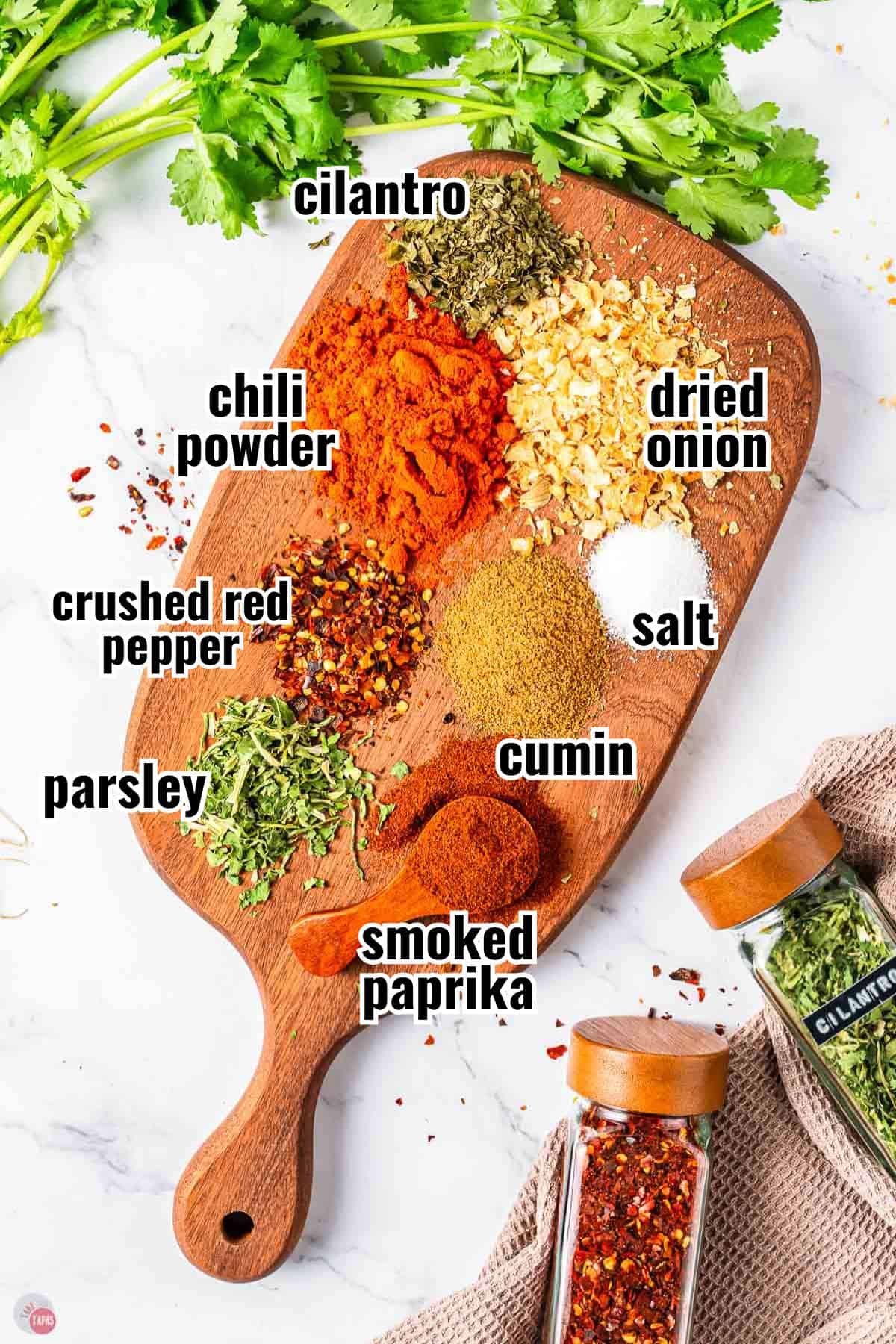 ingredients for Southwest spice mix on a wood board with text overlay labeling them