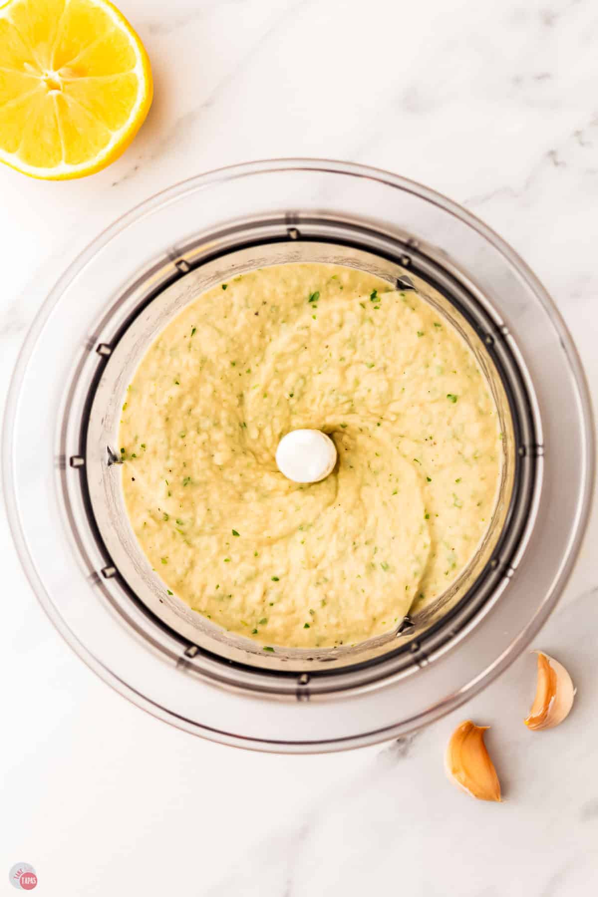 hummus being pureed in a food processor