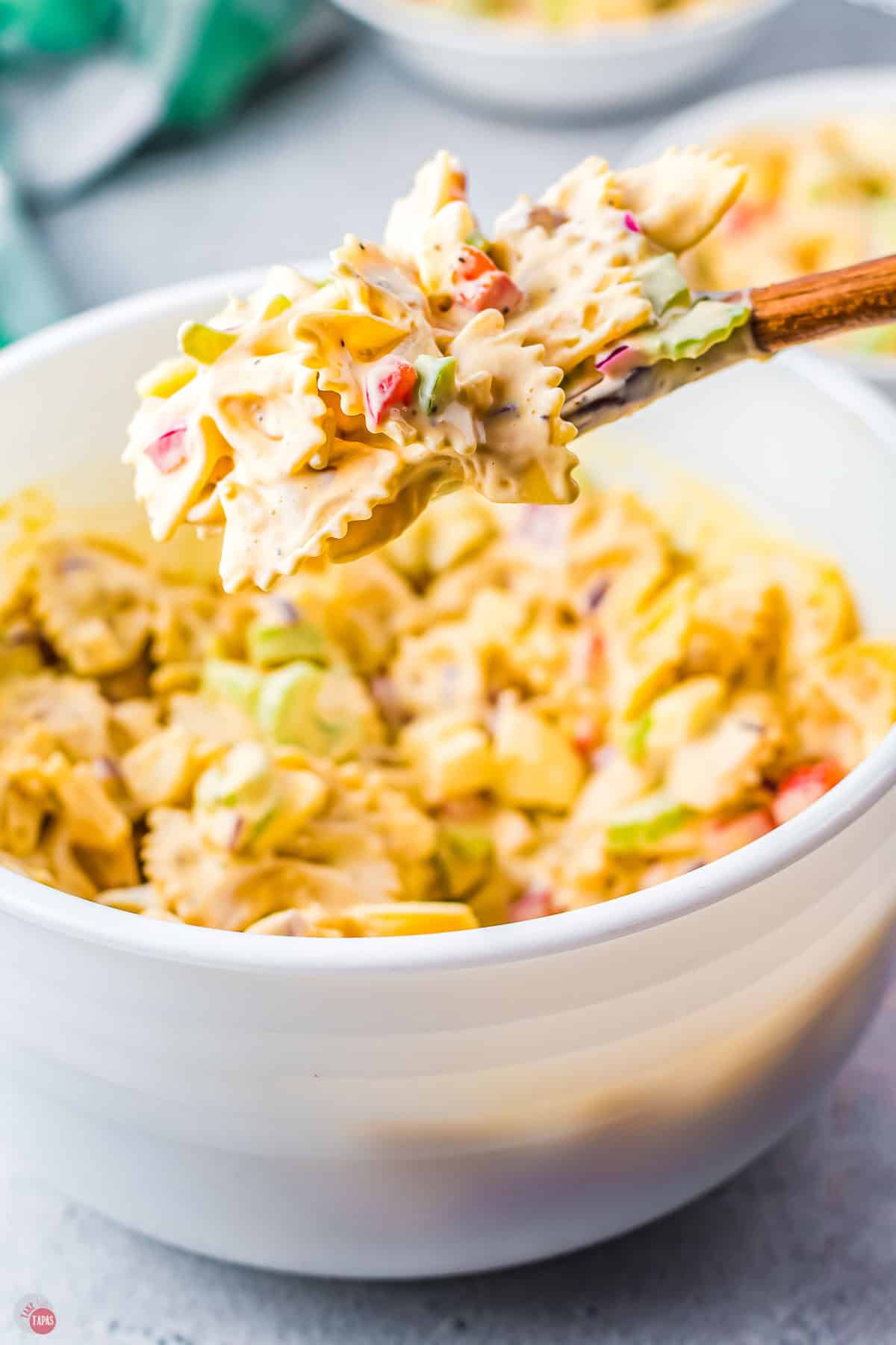 wood spoon with scoop of amish pasta salad on it