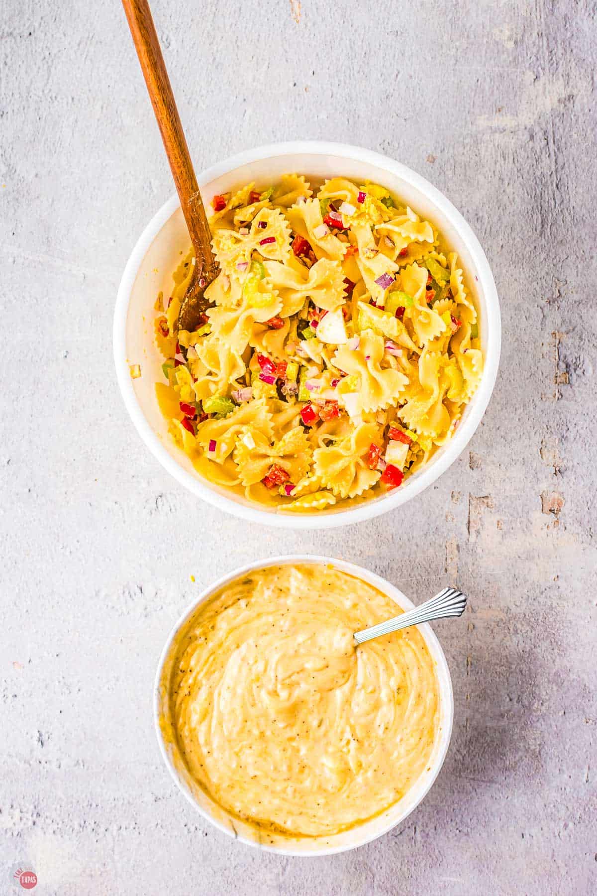 two bowls of pasta salad ingredients