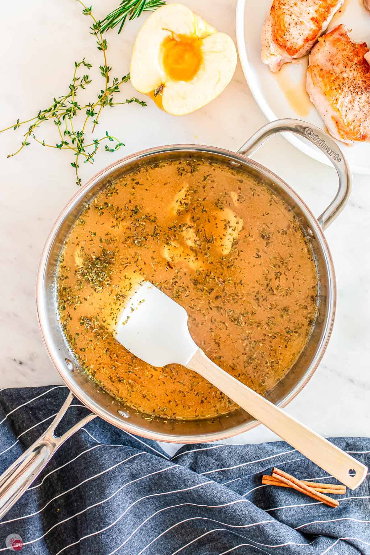 skillet with broth in it and a spatula stirring it