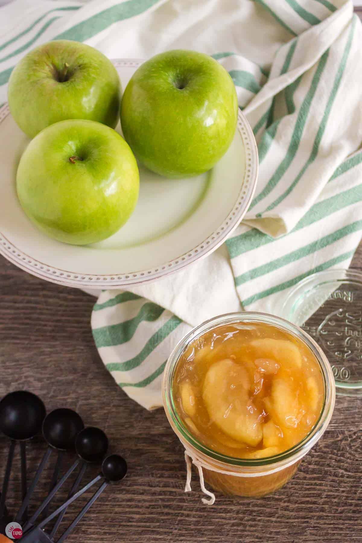 platter of green apples and a jar of pie filling