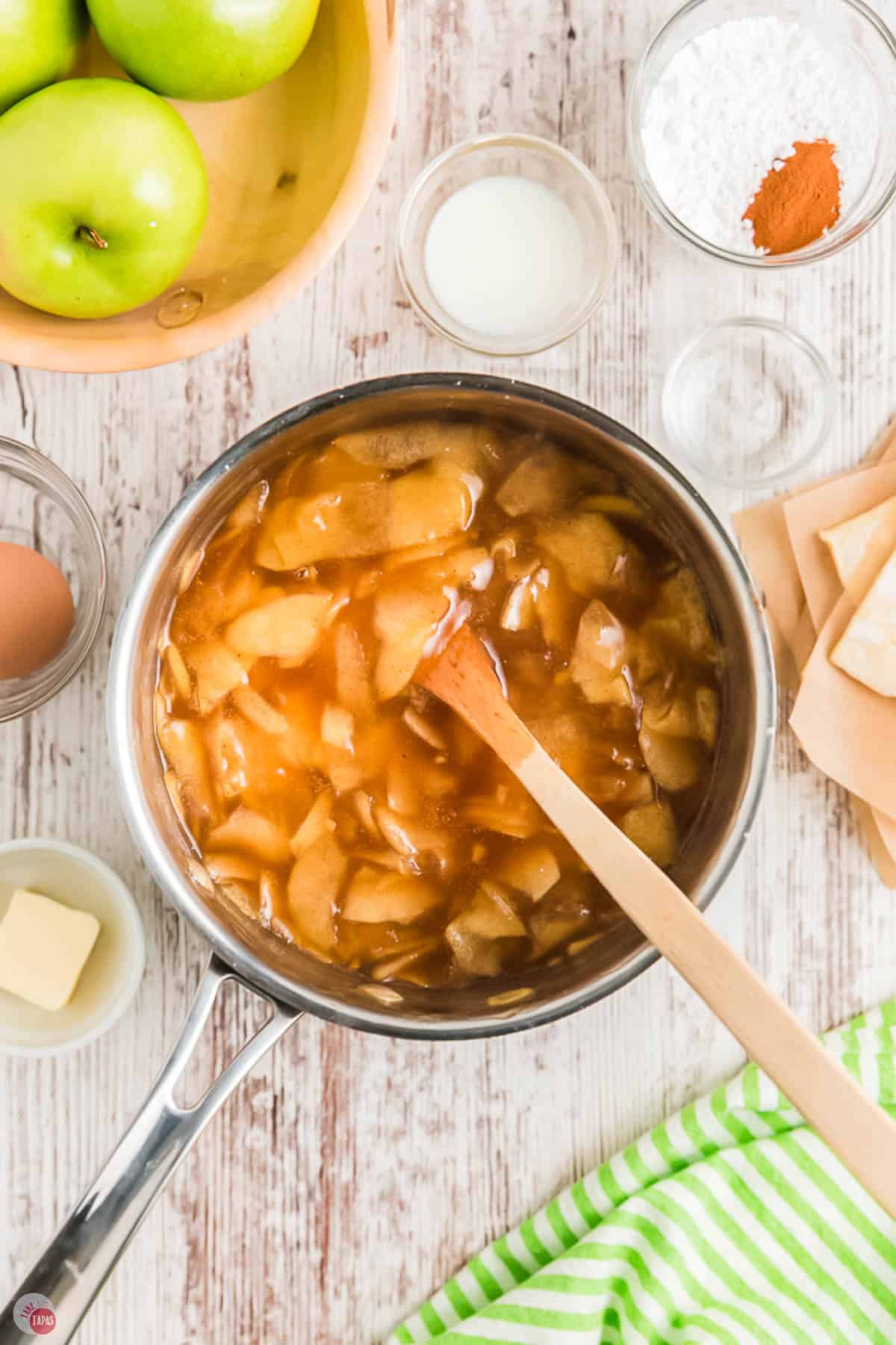 pot of apple pie filling with a wood spoon