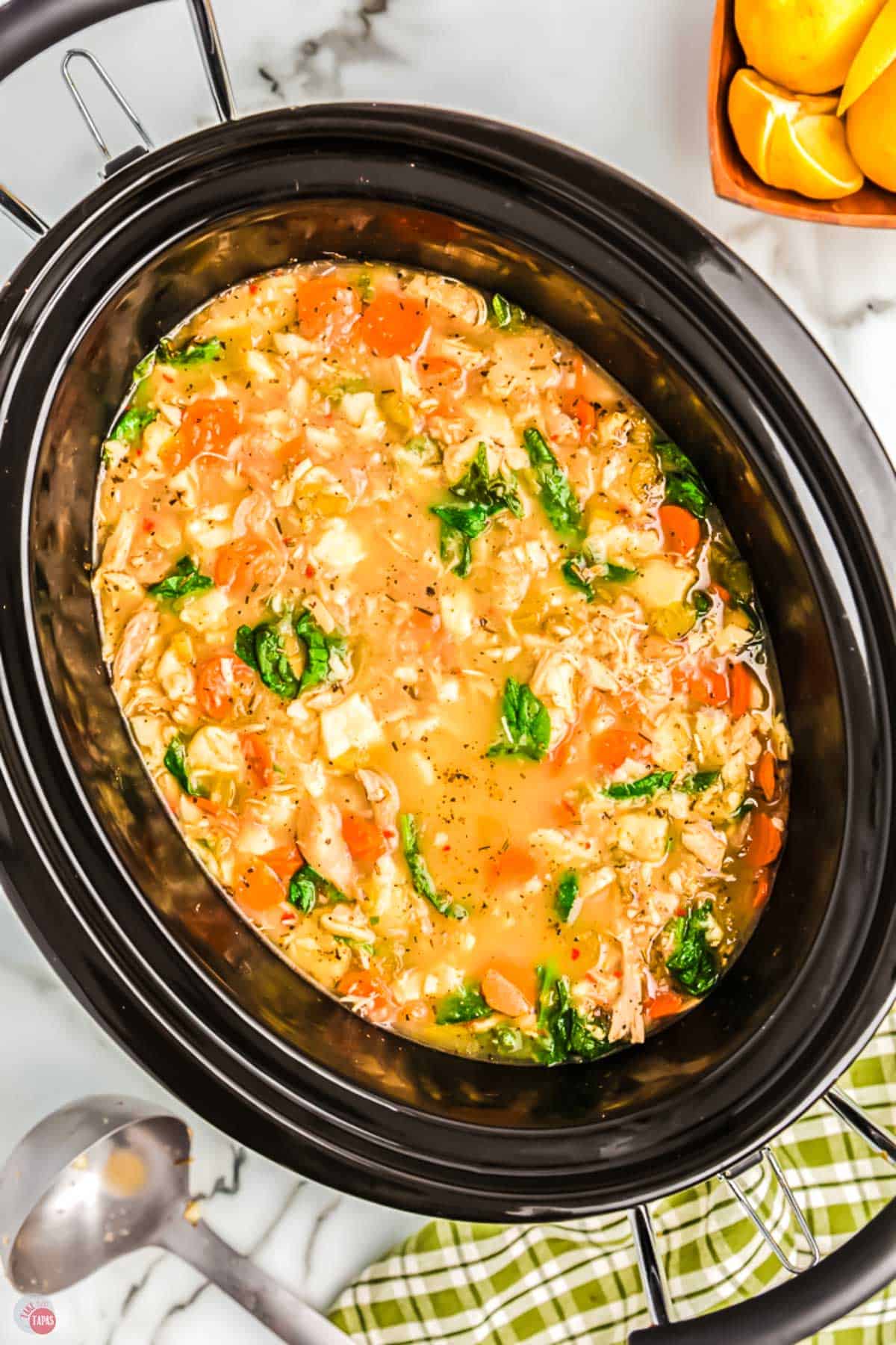 black crockpot bowl with chicken soup