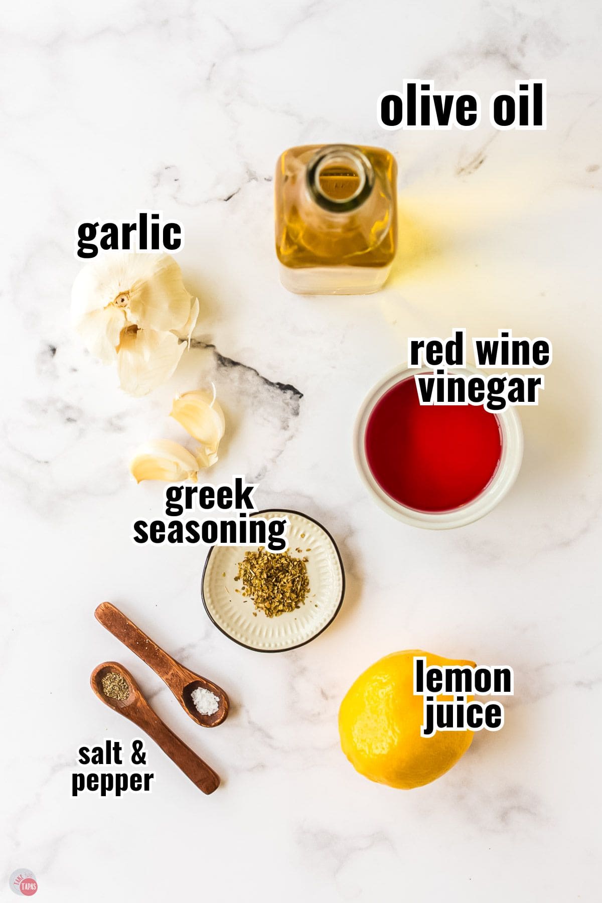 ingredients for a salad dressing recipe in individual bowls with text overlay labeling them
