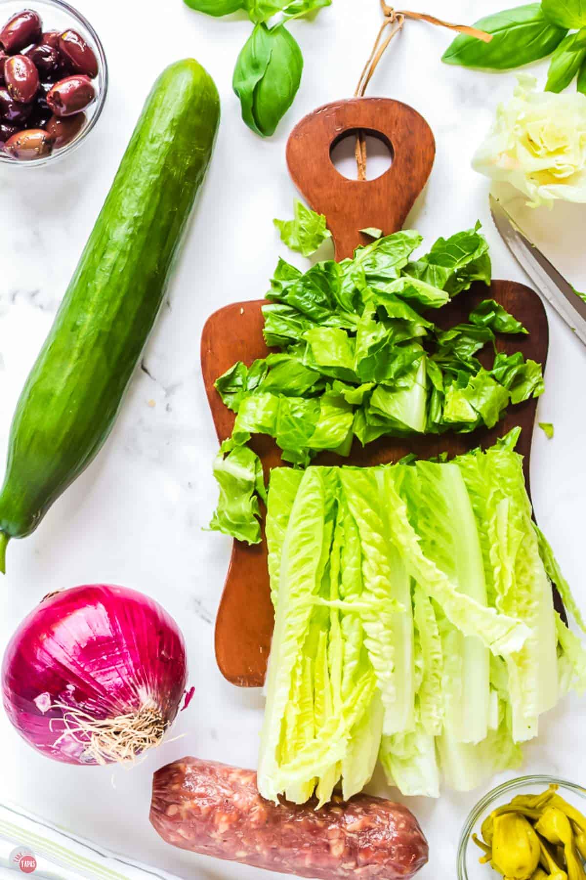 romaine heart being sliced across on a cutting board