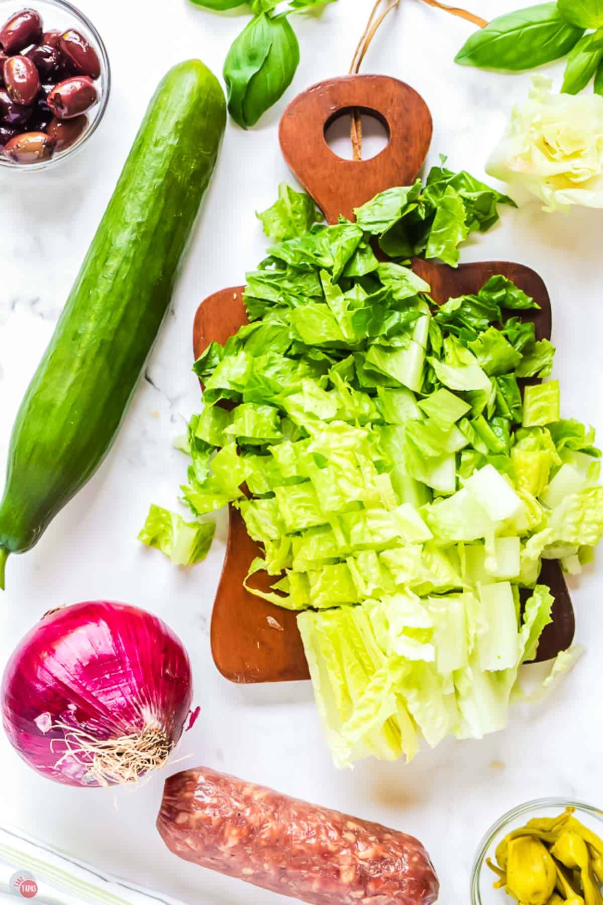 chopped romaine lettuce on a cutting board with a knife