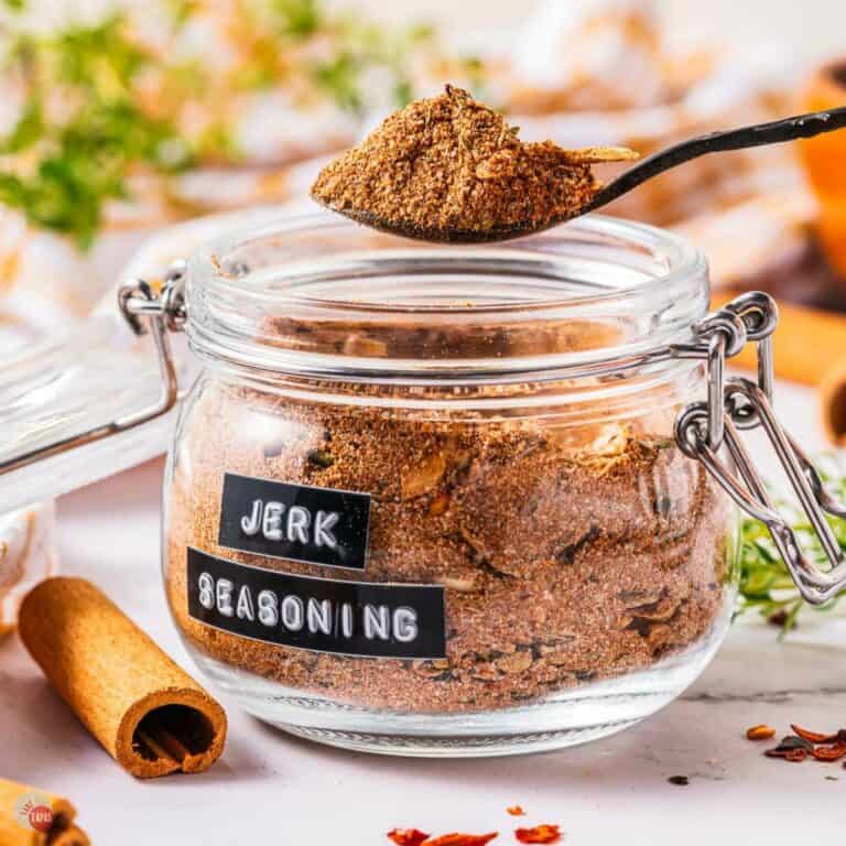 Jar of spice mix with a spoon over it