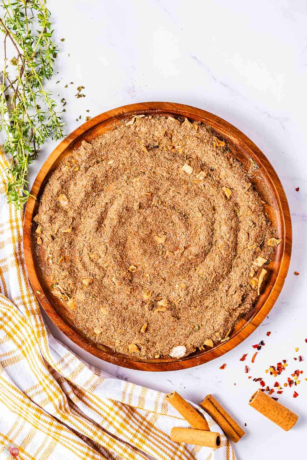 wood plate with jerk seasoning spread on it