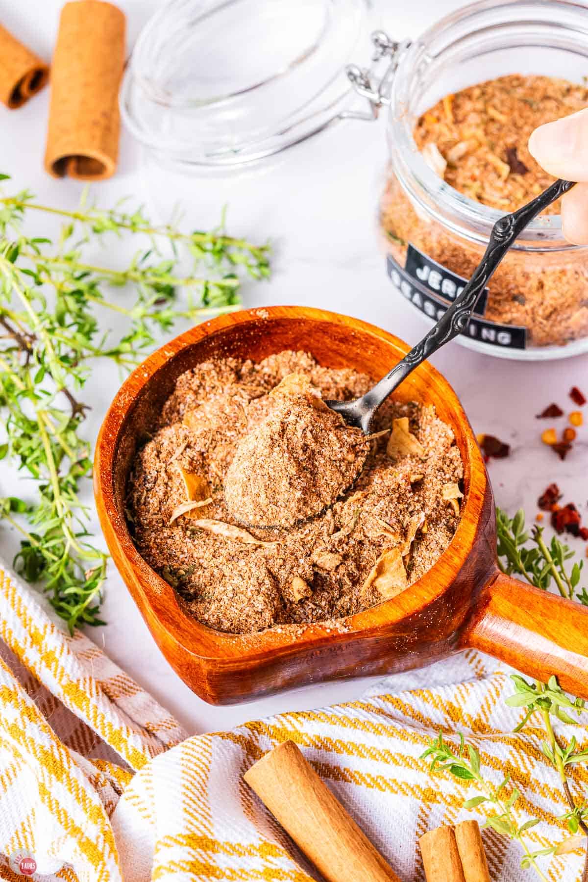 small terra cotta bowl of spice mix with a spoon