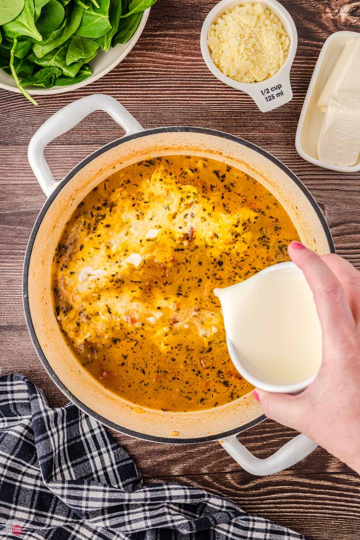 soup with cream being poured in
