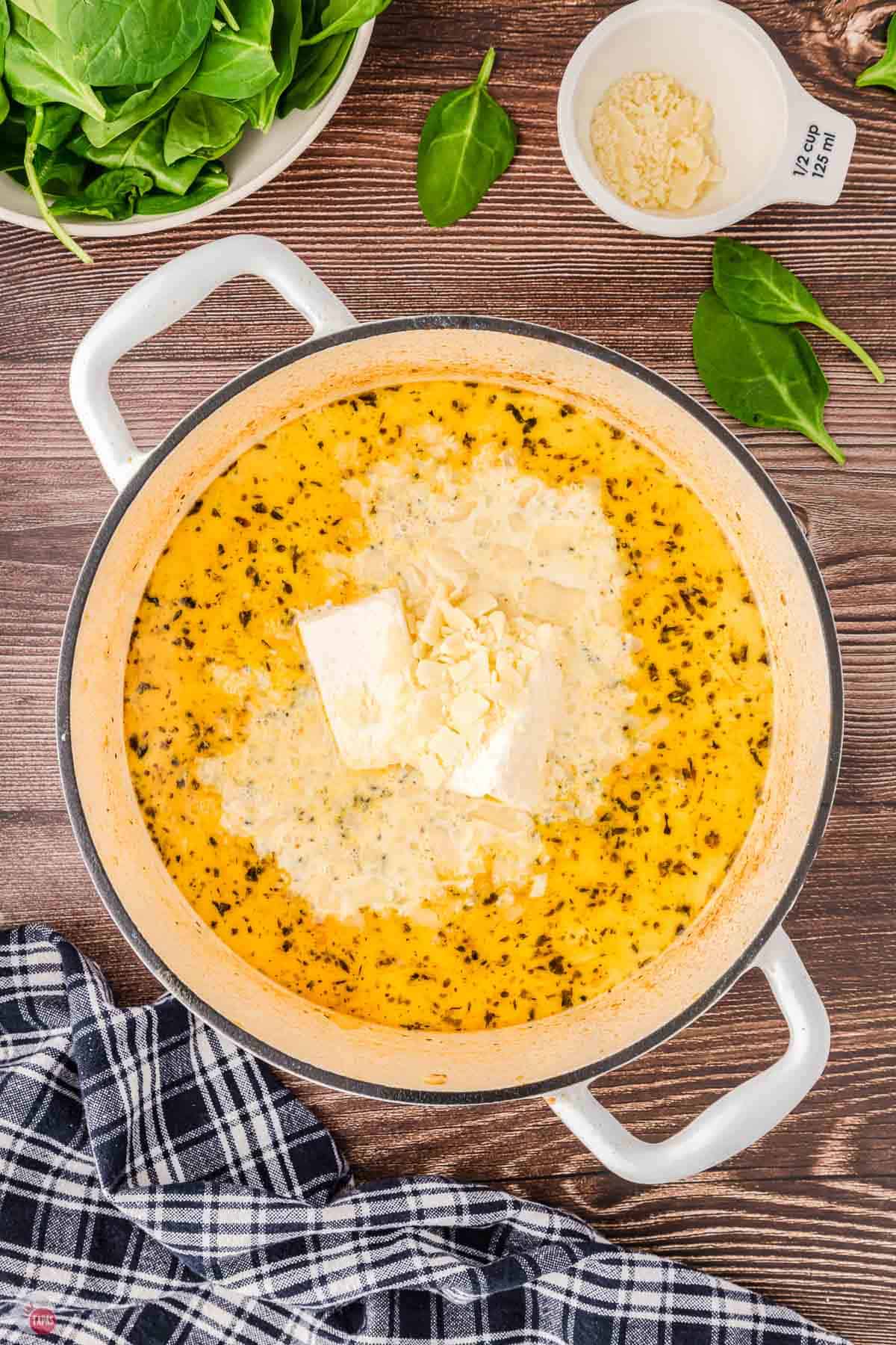 pot of broth with cream cheese and parmesan in it