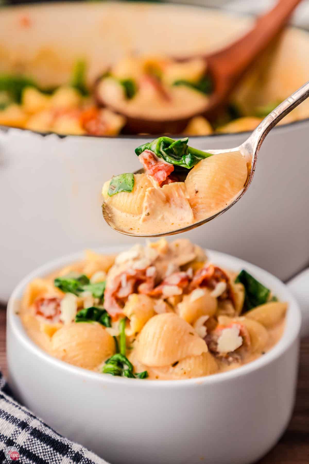 two bowls of soup with a spoon hovering over one