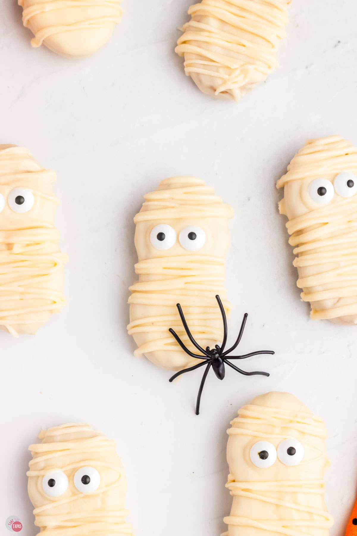 mummy cookies with a black spider on a white background
