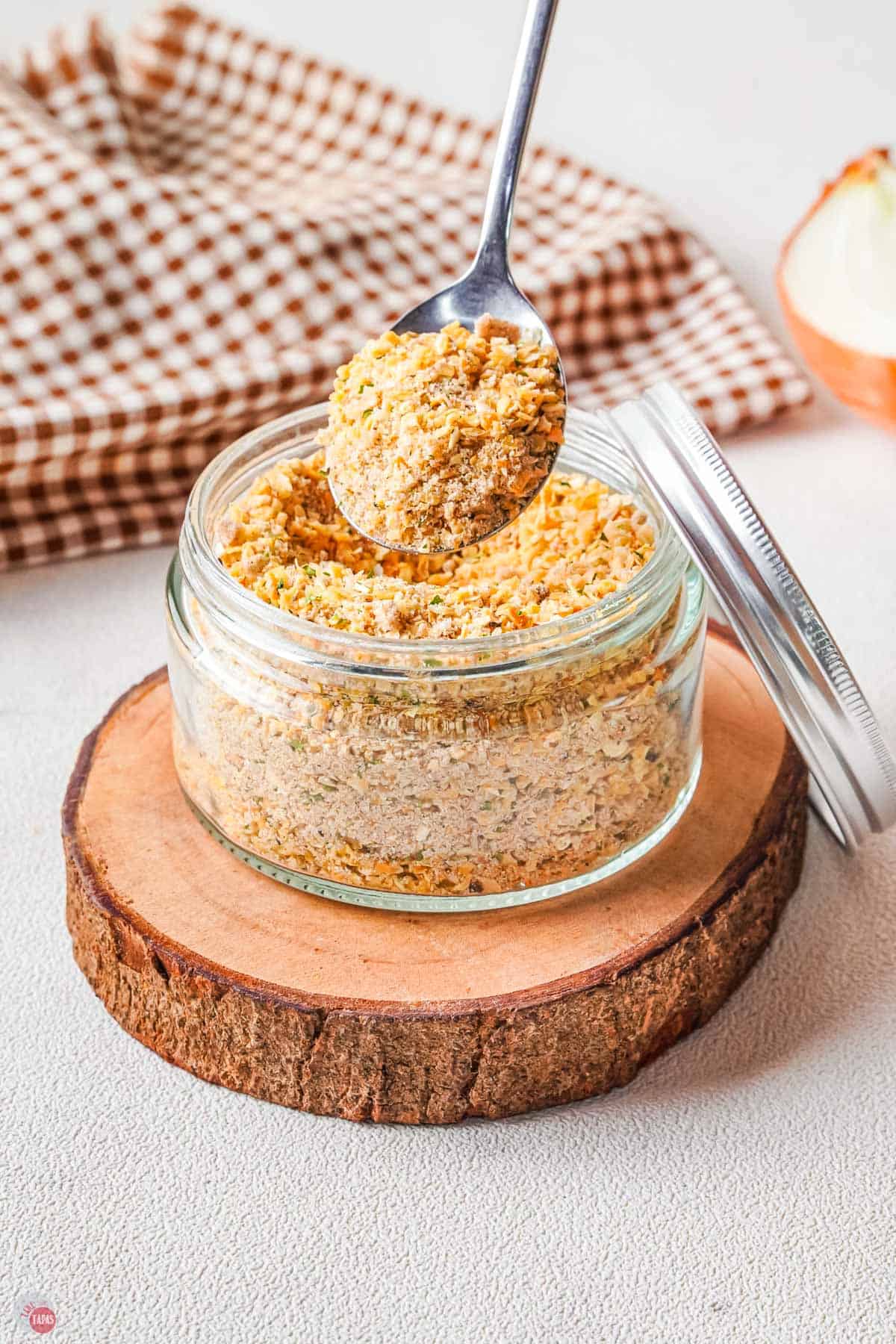 jar of dry soup mix with a spoon taking a scoop out