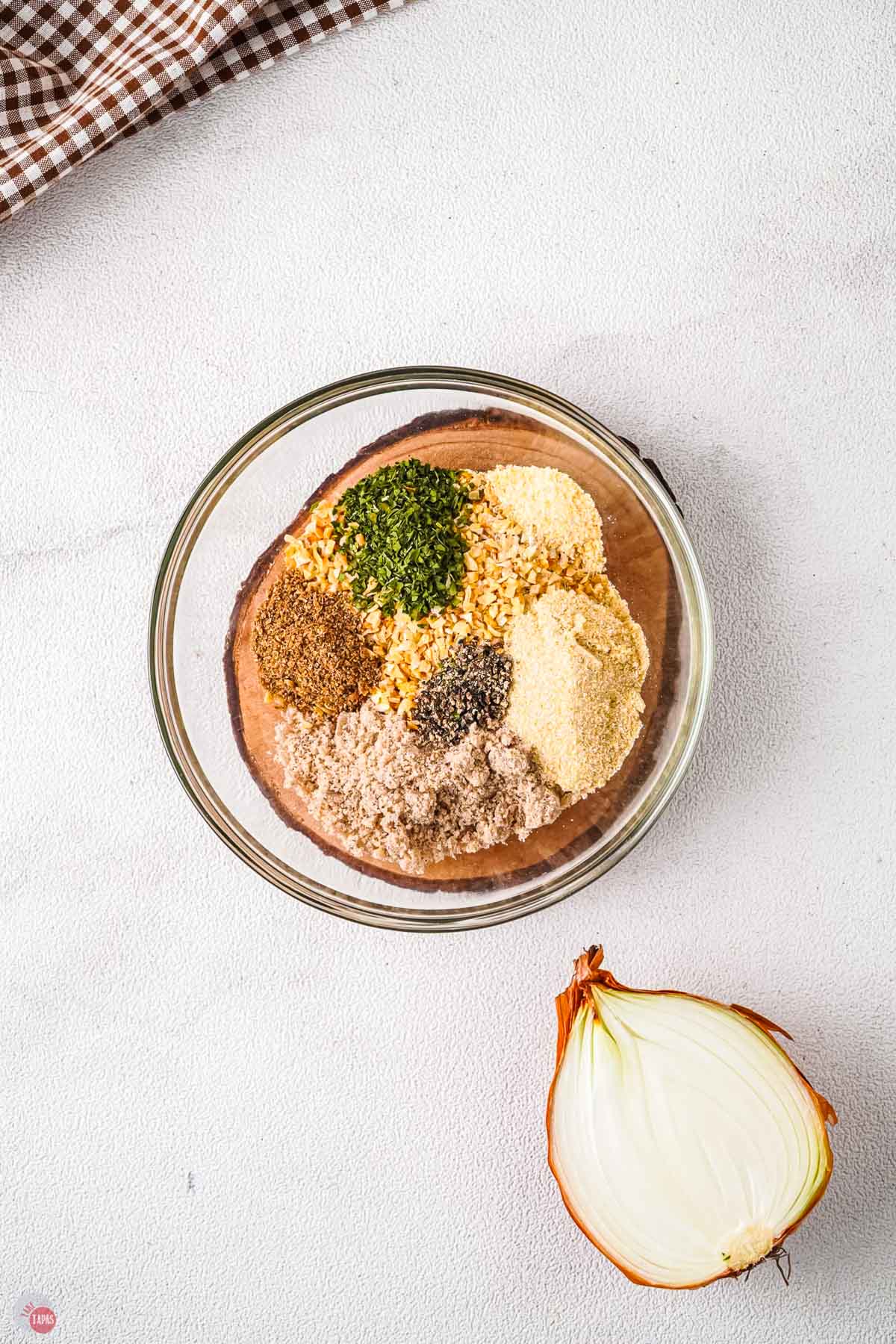 clear bowl with small piles of spices in it