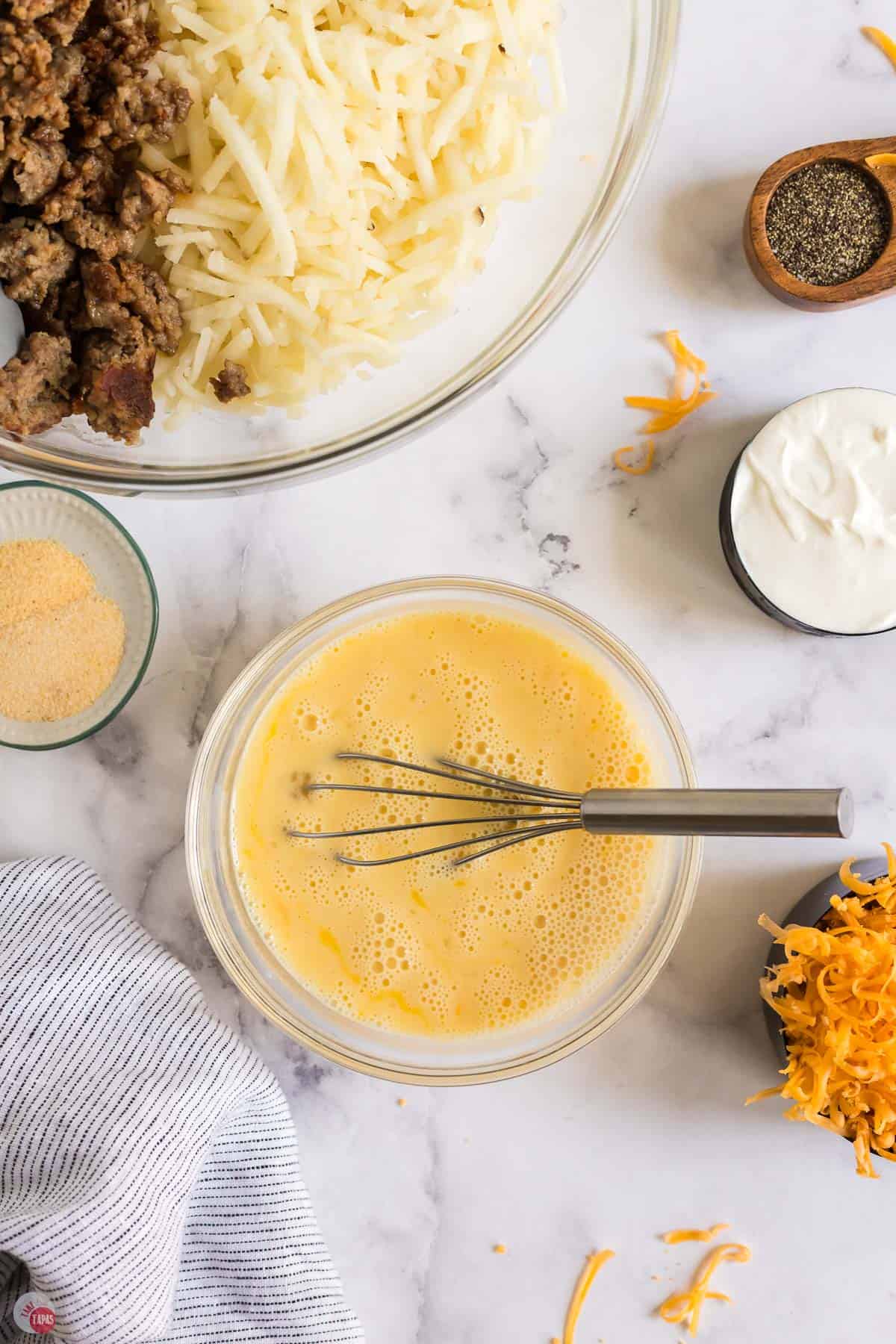 egg mixture in a bowl with a whisk