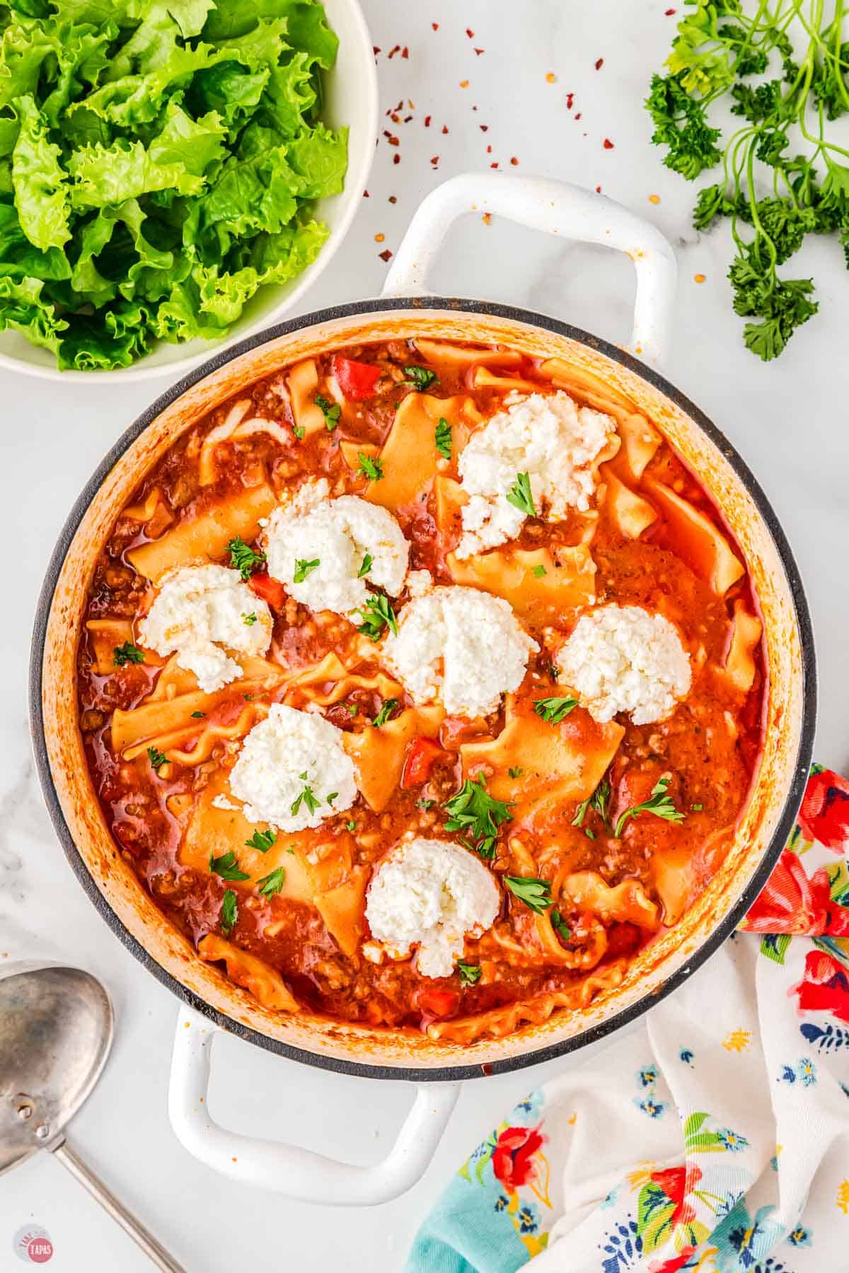 pot of soup with spoonfuls of ricotta cheese in it