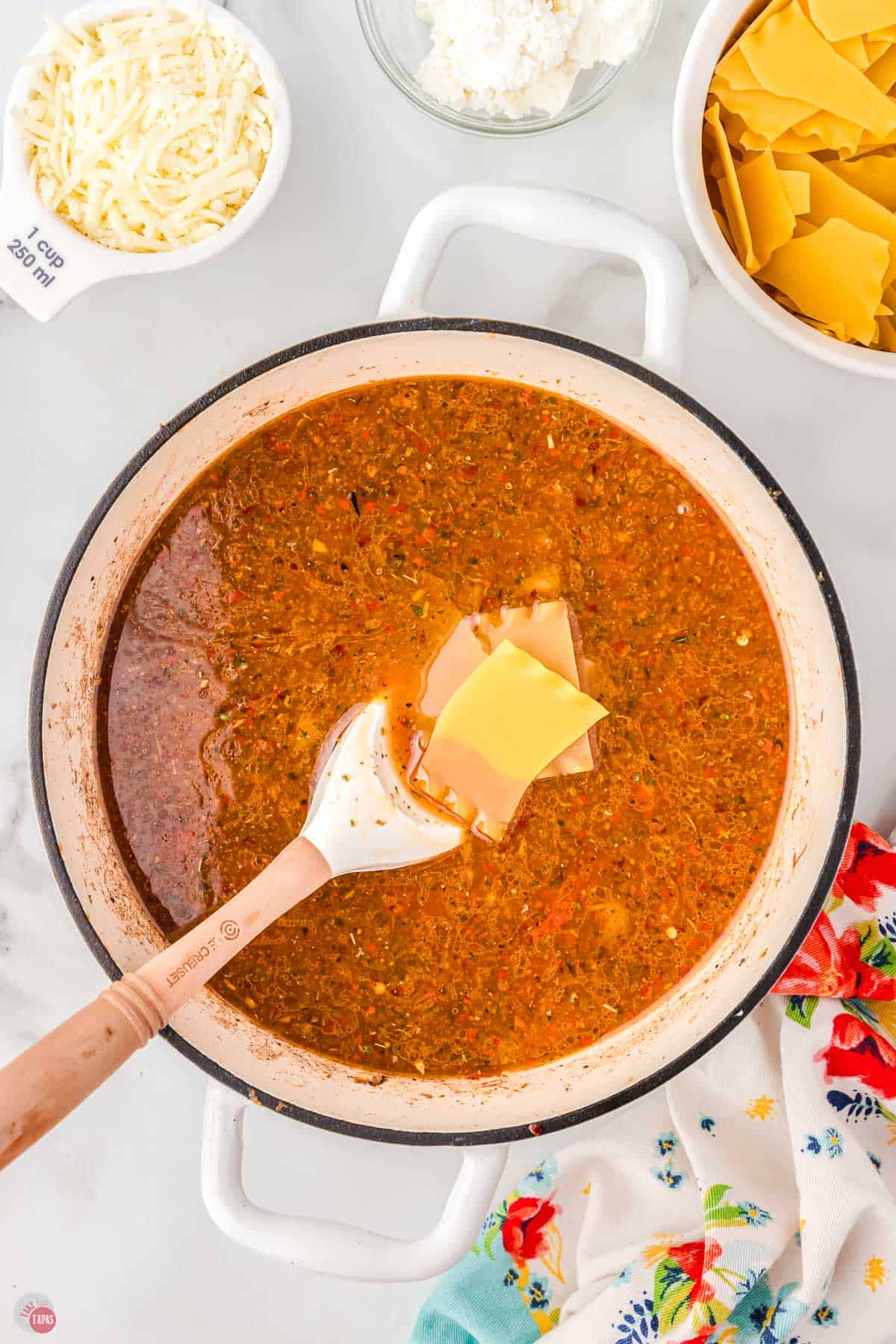 pot of broth with uncooked lasagna noodles