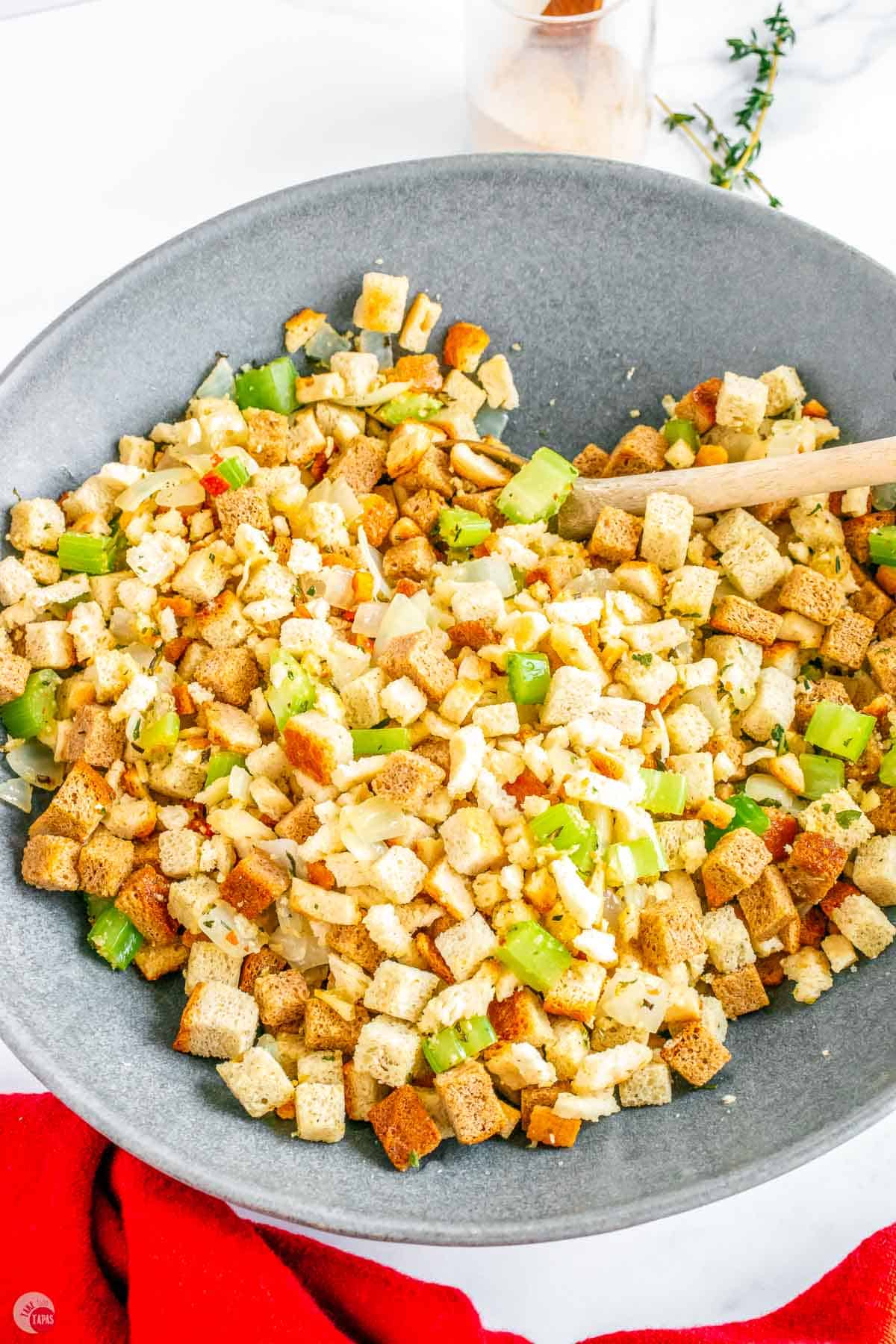 bowl of dry stuffing mix with cooked celery and onions