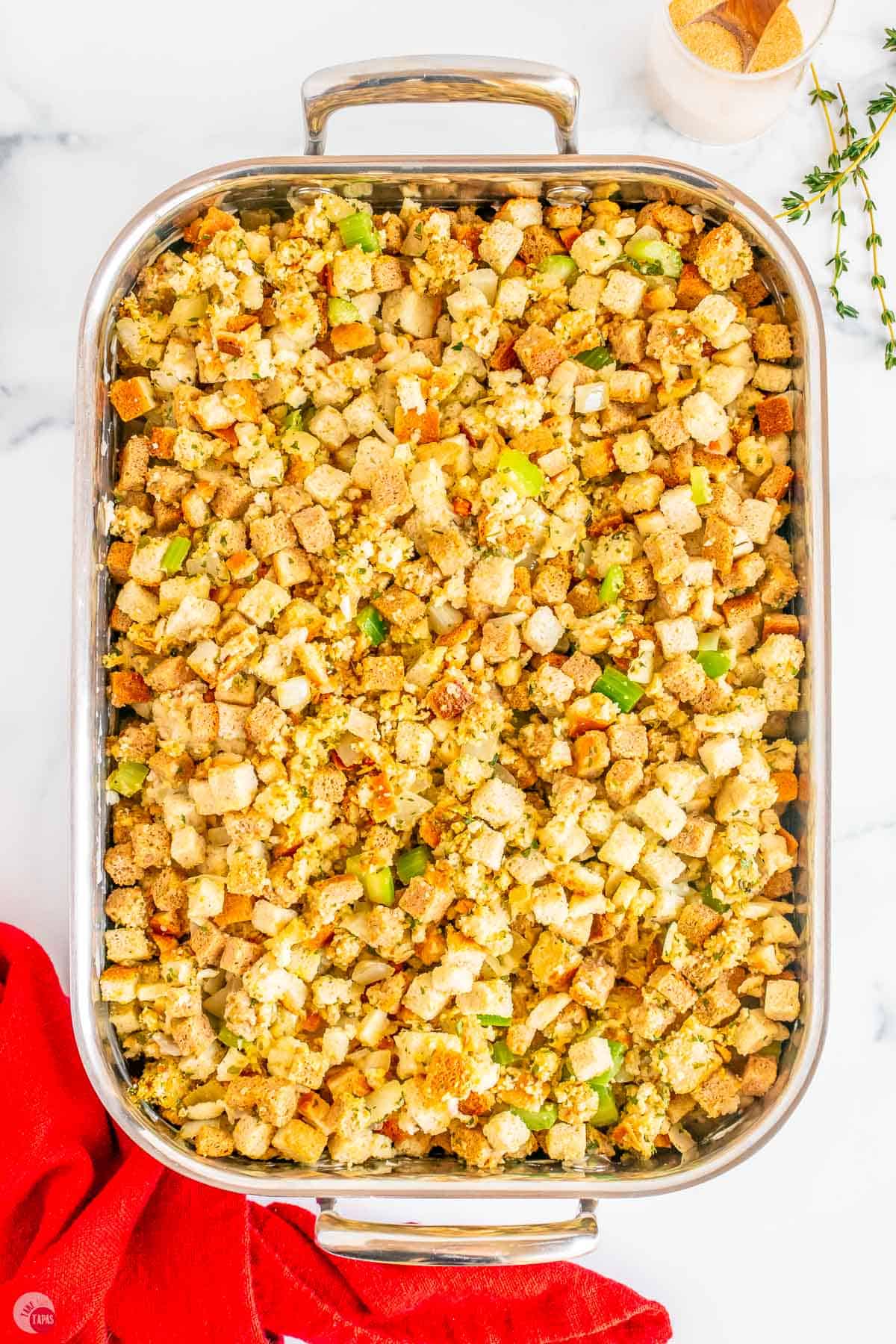 silver baking dish with uncooked dressing in it