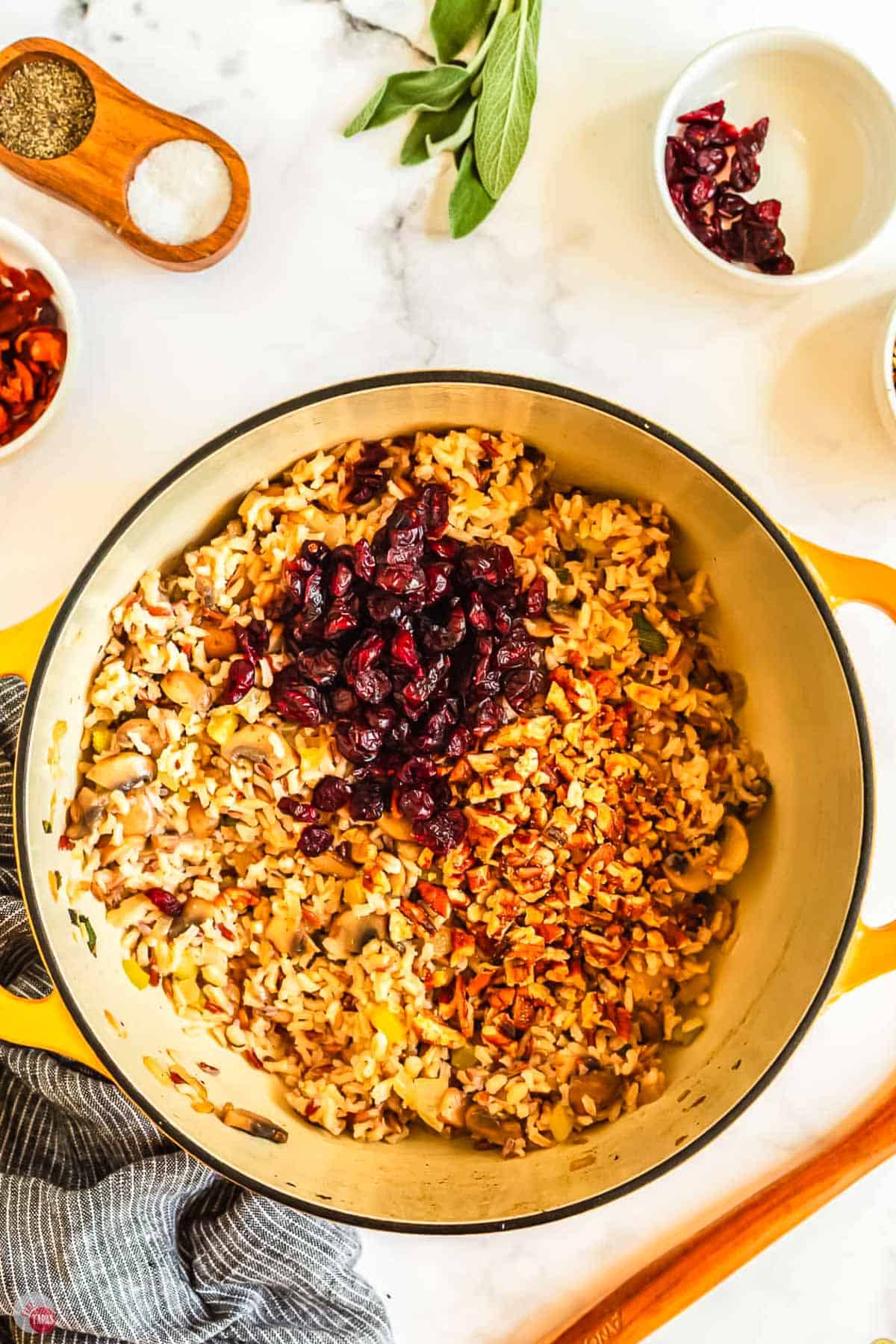 rice, pecans, and cranberries in a pot