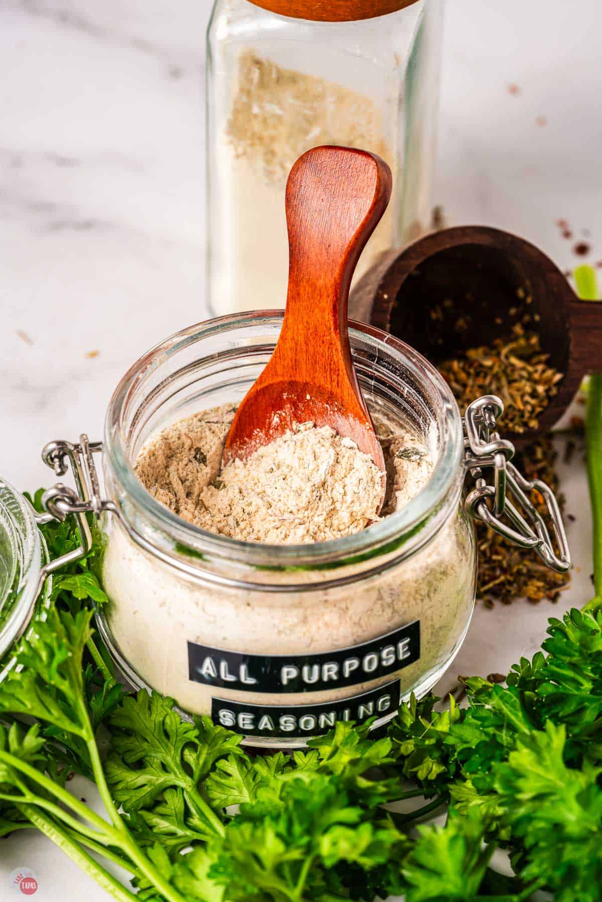 jar of seasoning with a wood spoon