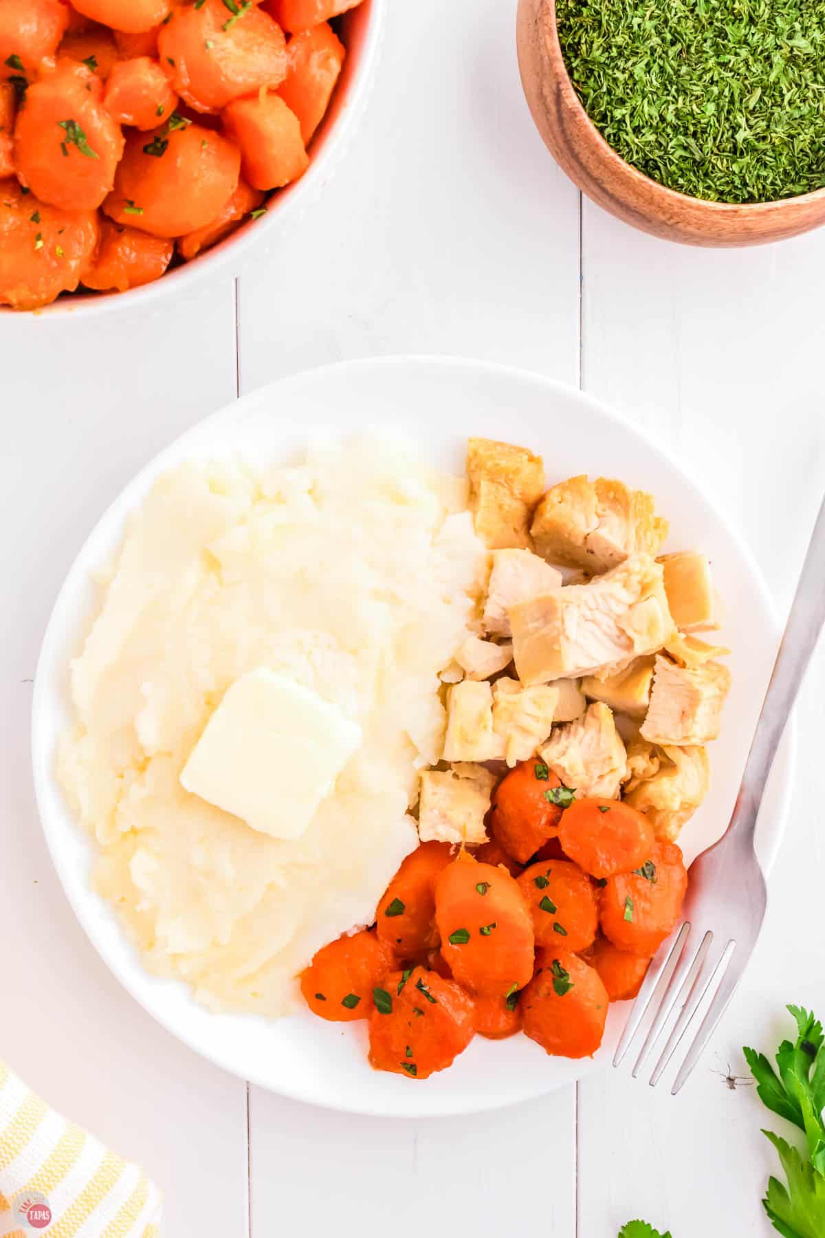 plate of mashed potatoes, chicken, and carrots