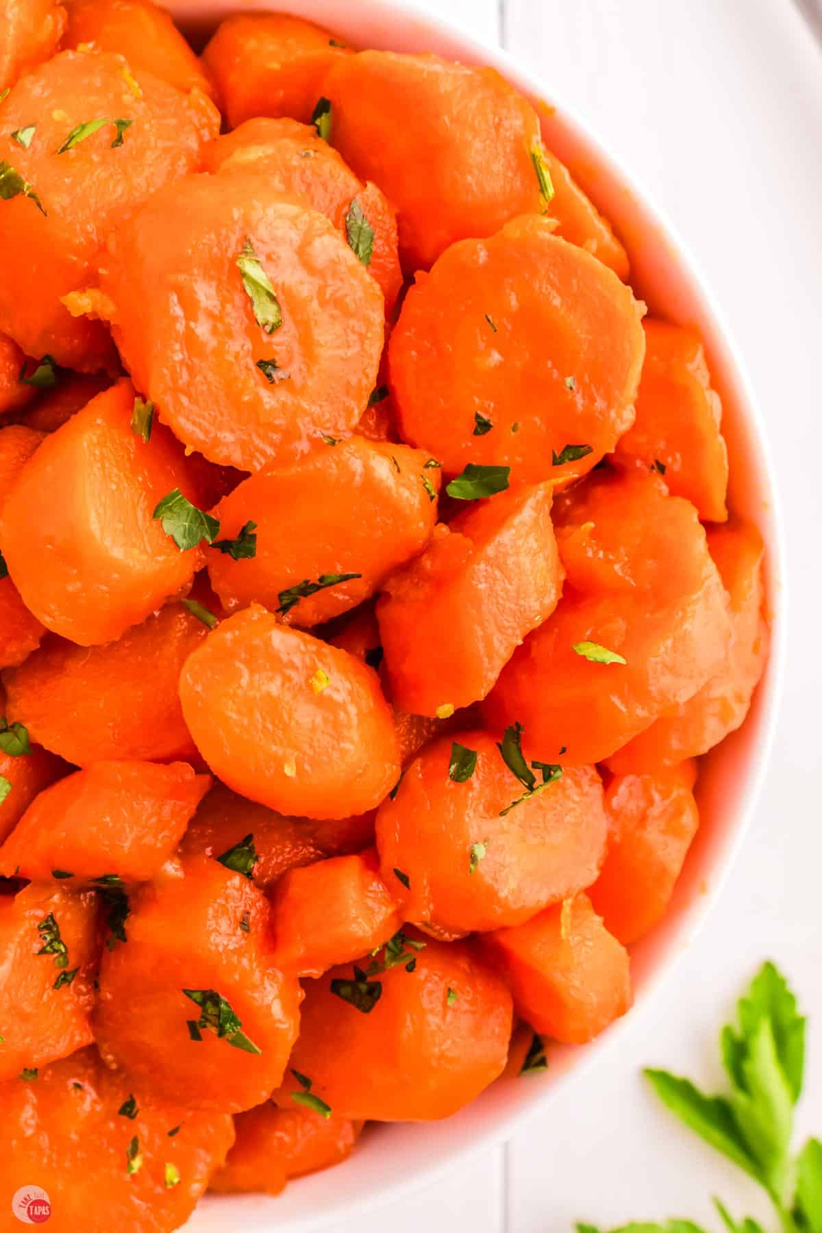 close up of brown sugar glazed carrots with parsley