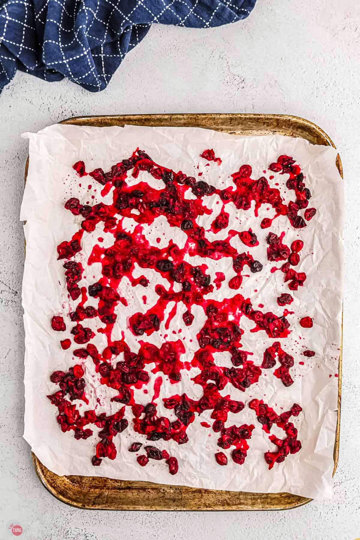 dried cranberries on a baking sheet with parchment paper